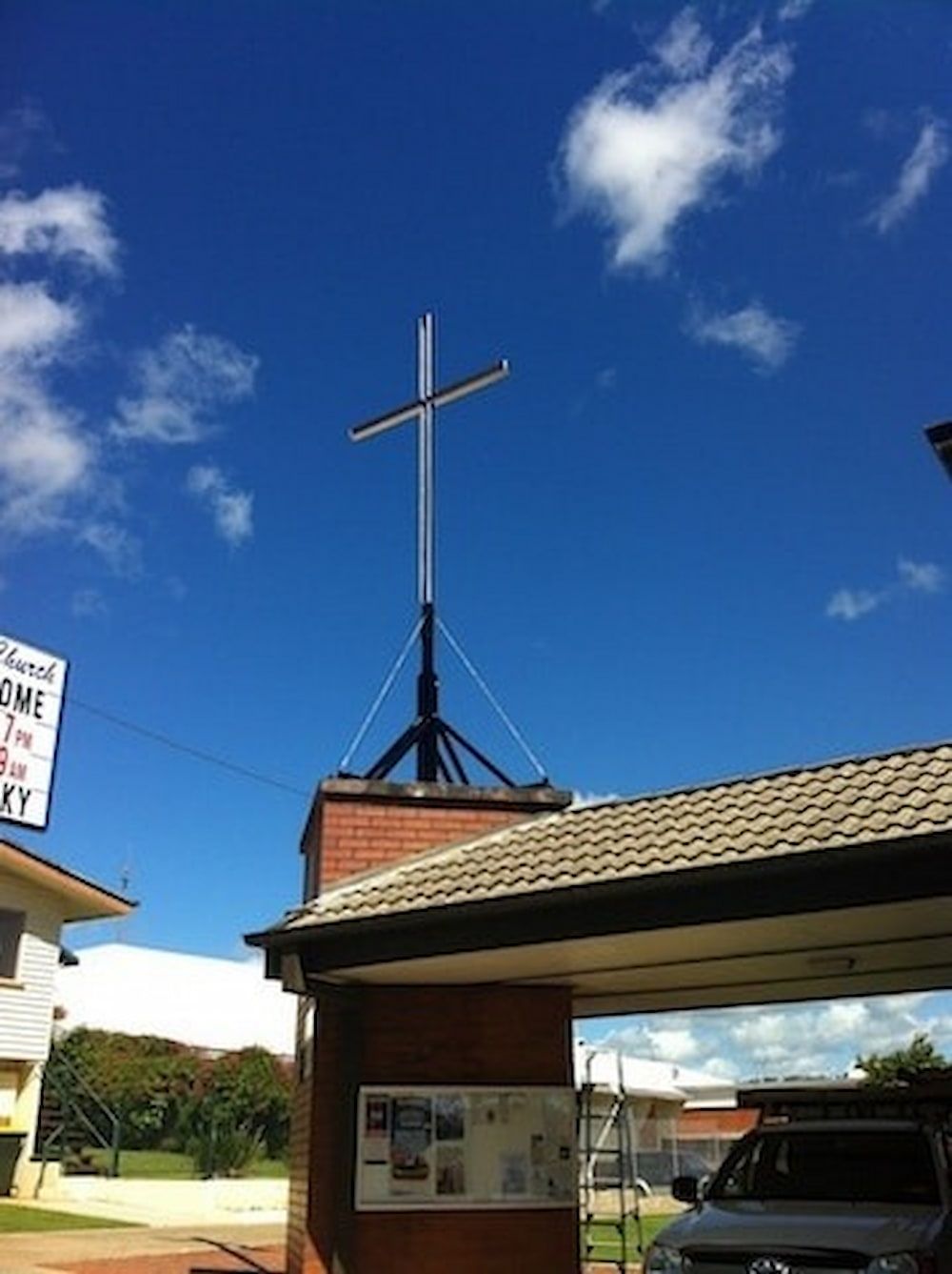 A Cross on Top of a Building With a Blue Sky in the Background — Metaltrendz in Kunda Park, QLD