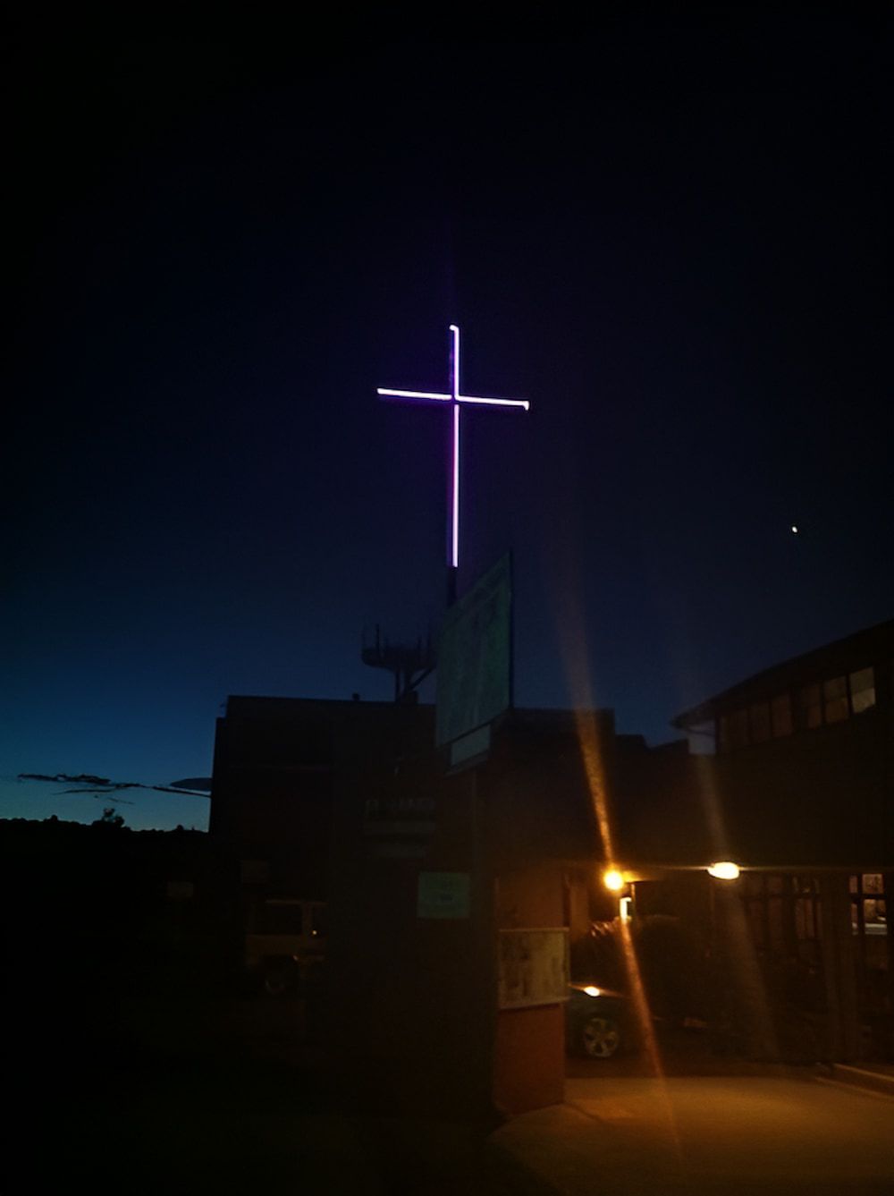A Large Cross is Lit Up in the Night Sky — Metaltrendz in Kunda Park, QLD