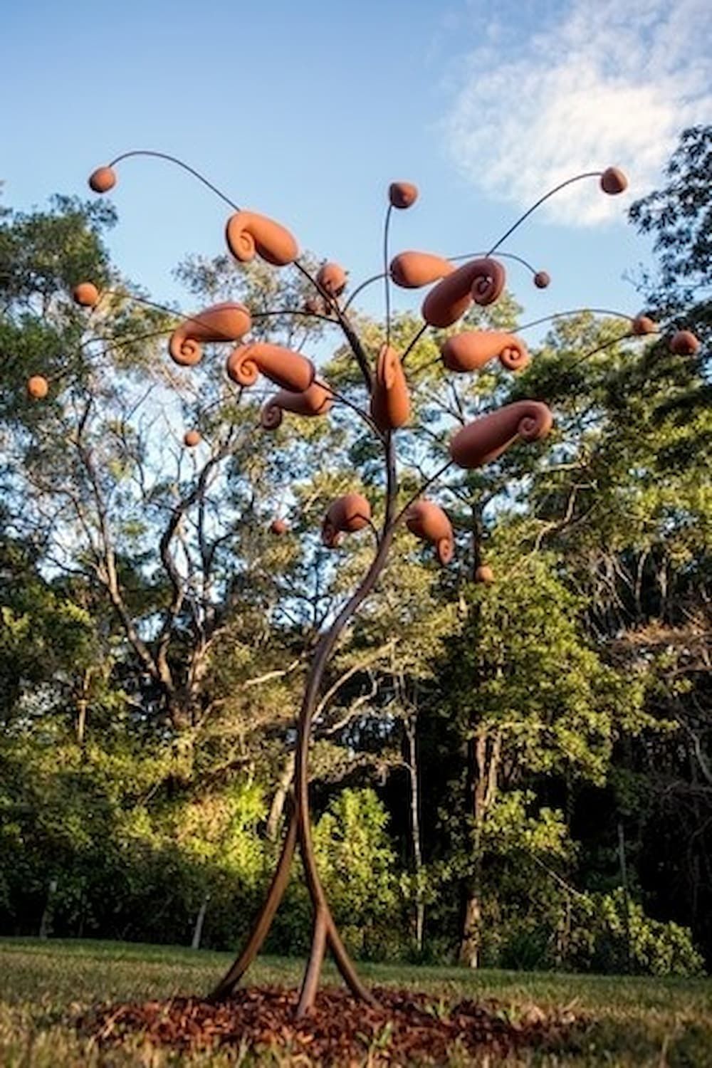 A Large Sculpture of a Tree in a Park With Trees in the Background — Metaltrendz in Kunda Park, QLD