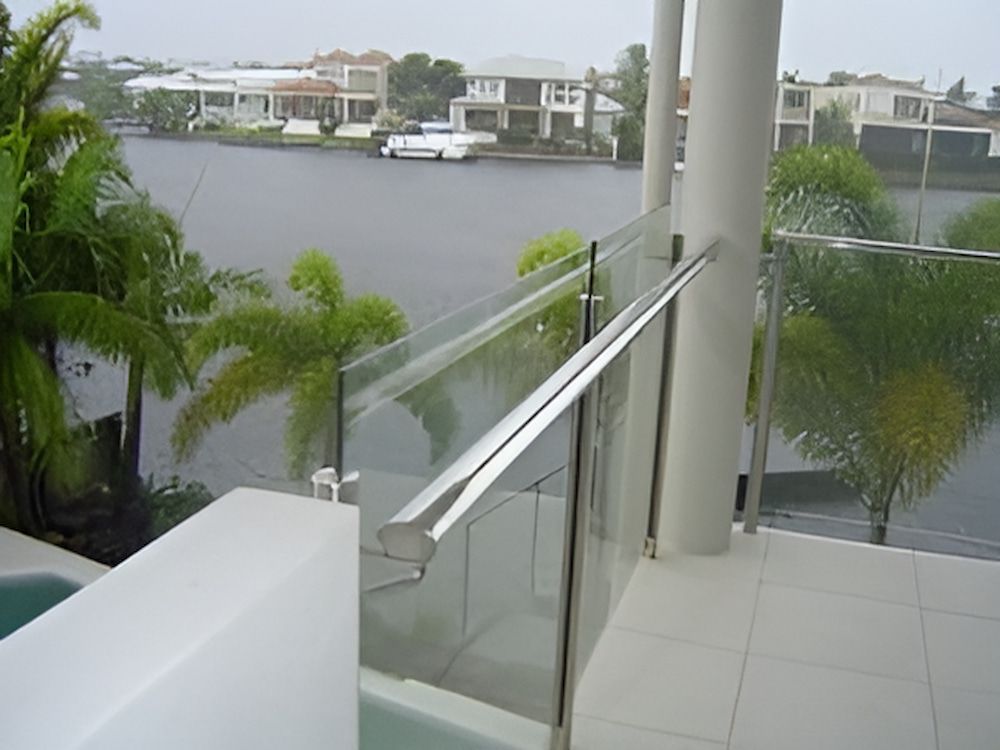 A Balcony With a Glass Railing Overlooking a Body of Water — Metaltrendz in Kunda Park, QLD