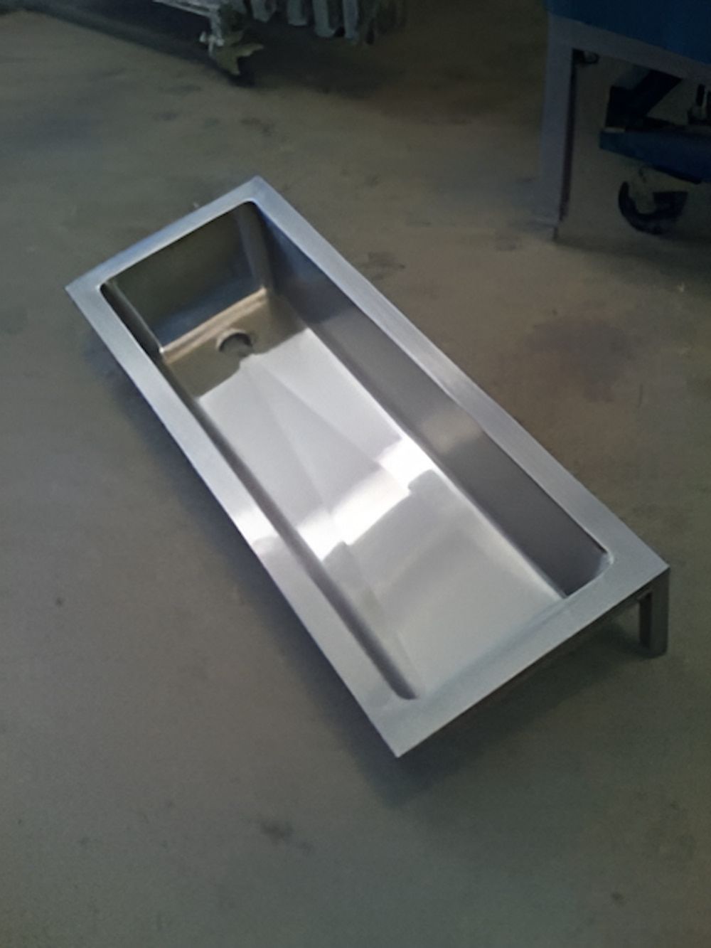 A Stainless Steel Sink is Sitting on a Concrete Floor — Metaltrendz in Kunda Park, QLD