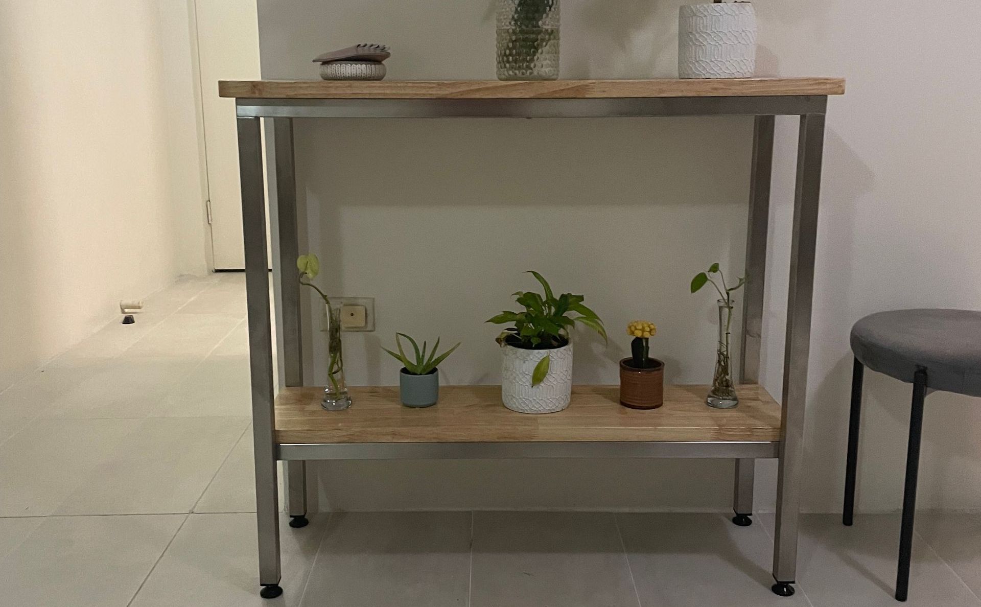 A console table with plants and a vase, next to a grey stool — Metaltrendz in Kunda Park, QLD
