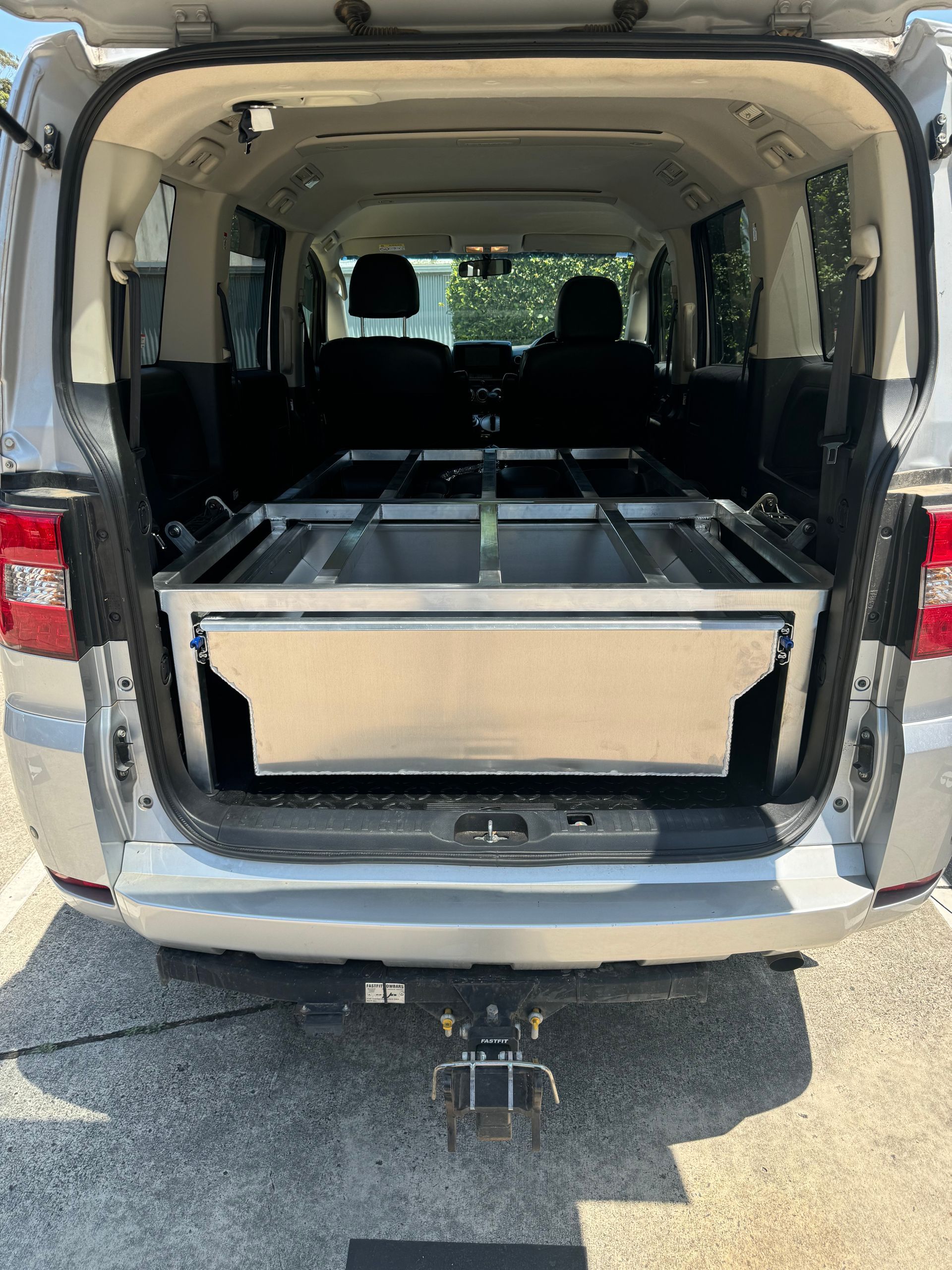 Silver hearse interior with a casket bed. Tailgate open — Metaltrendz in Kunda Park, QLD