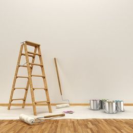 A ladder in a room being decorated