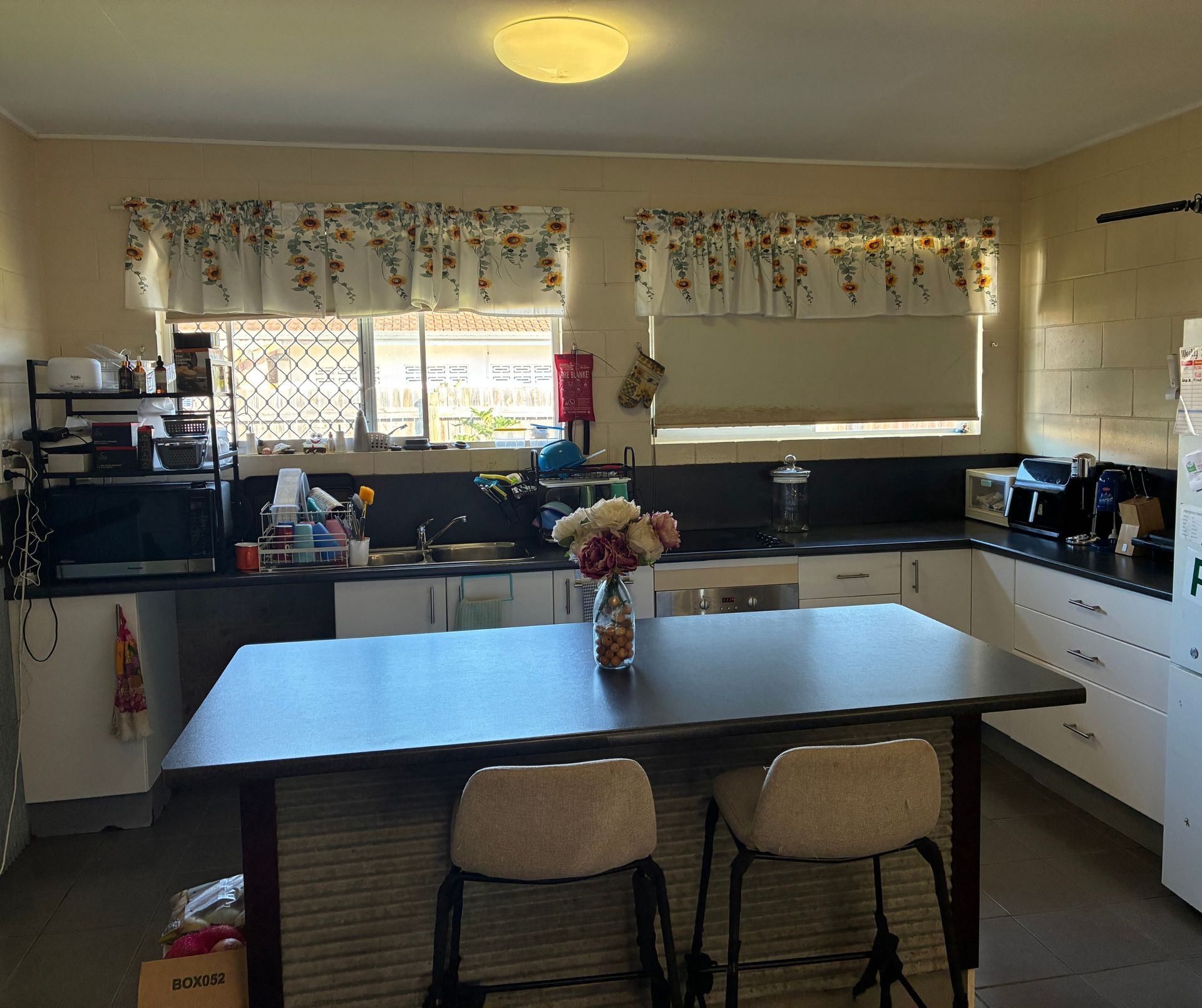 Kitchen With White Cabinets, Dark Countertop — Schmucker Cleaning in Gulliver, QLD