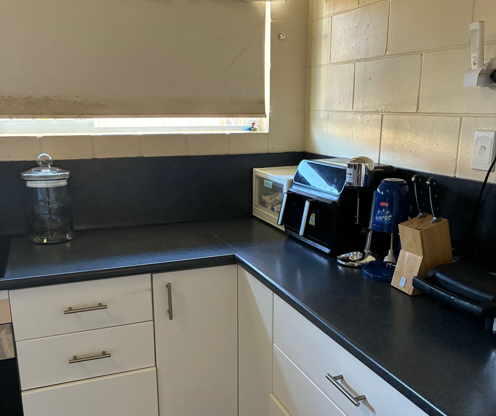 Kitchen Counter With Appliances: Microwave, Coffee Machine — Schmucker Cleaning in Gulliver, QLD