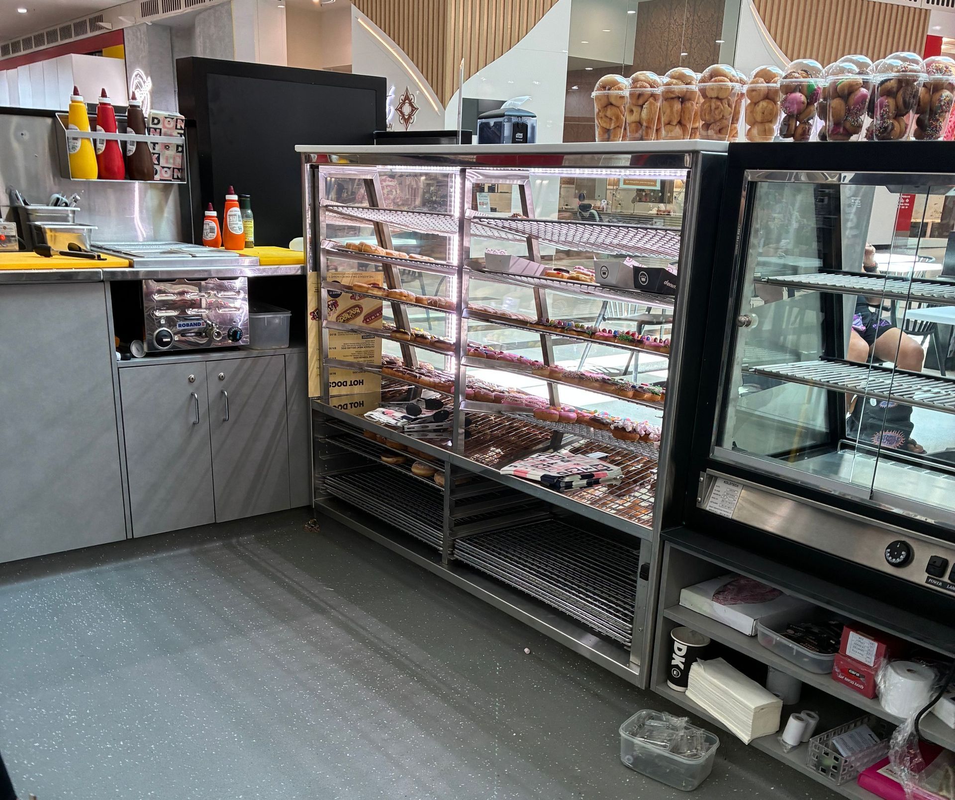 Donut Display Case at a Food Establishment, Filled With Various Donuts — Schmucker Cleaning in Gulliver, QLD