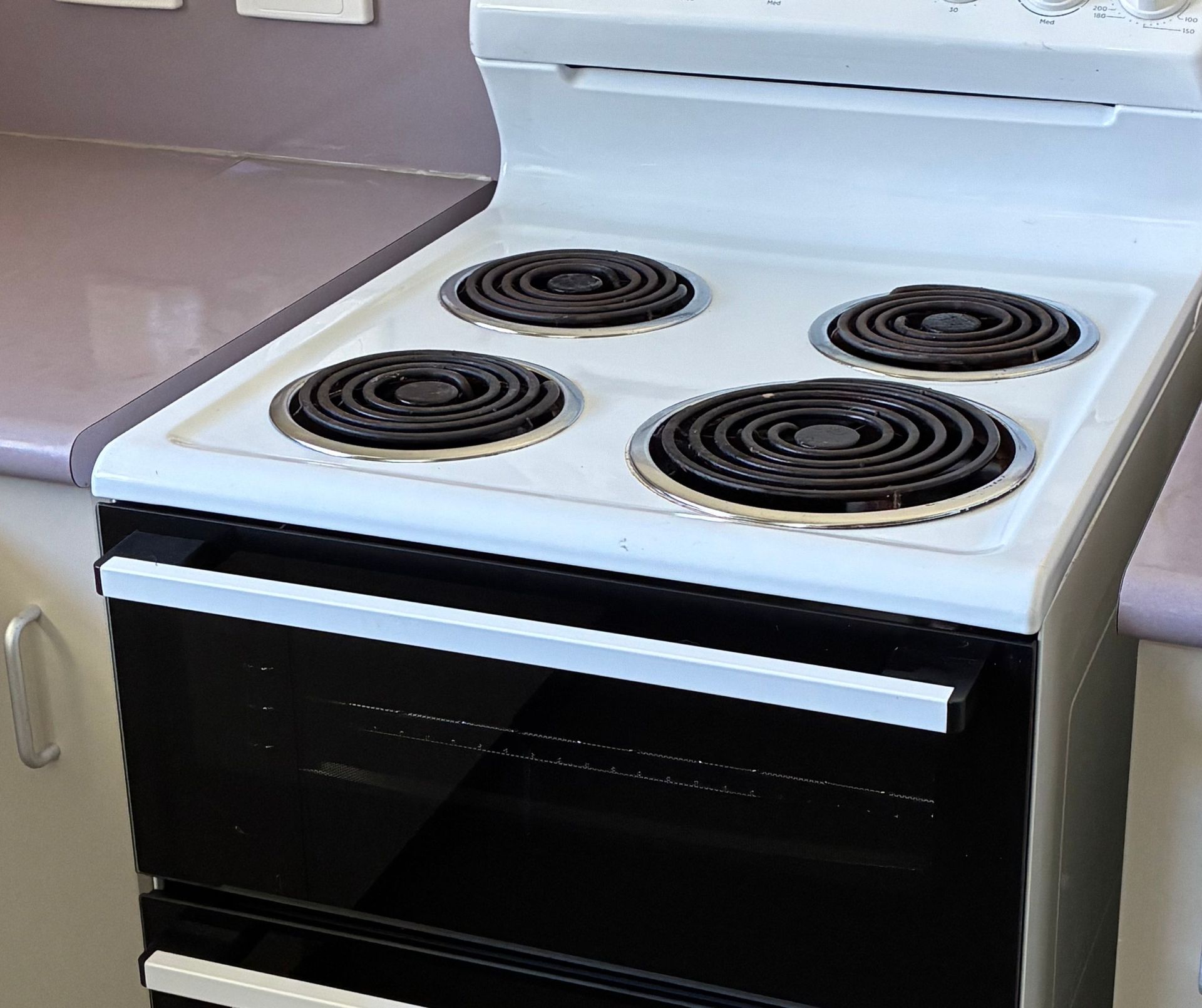 White Electric Stove With Four Burners — Schmucker Cleaning in Gulliver, QLD