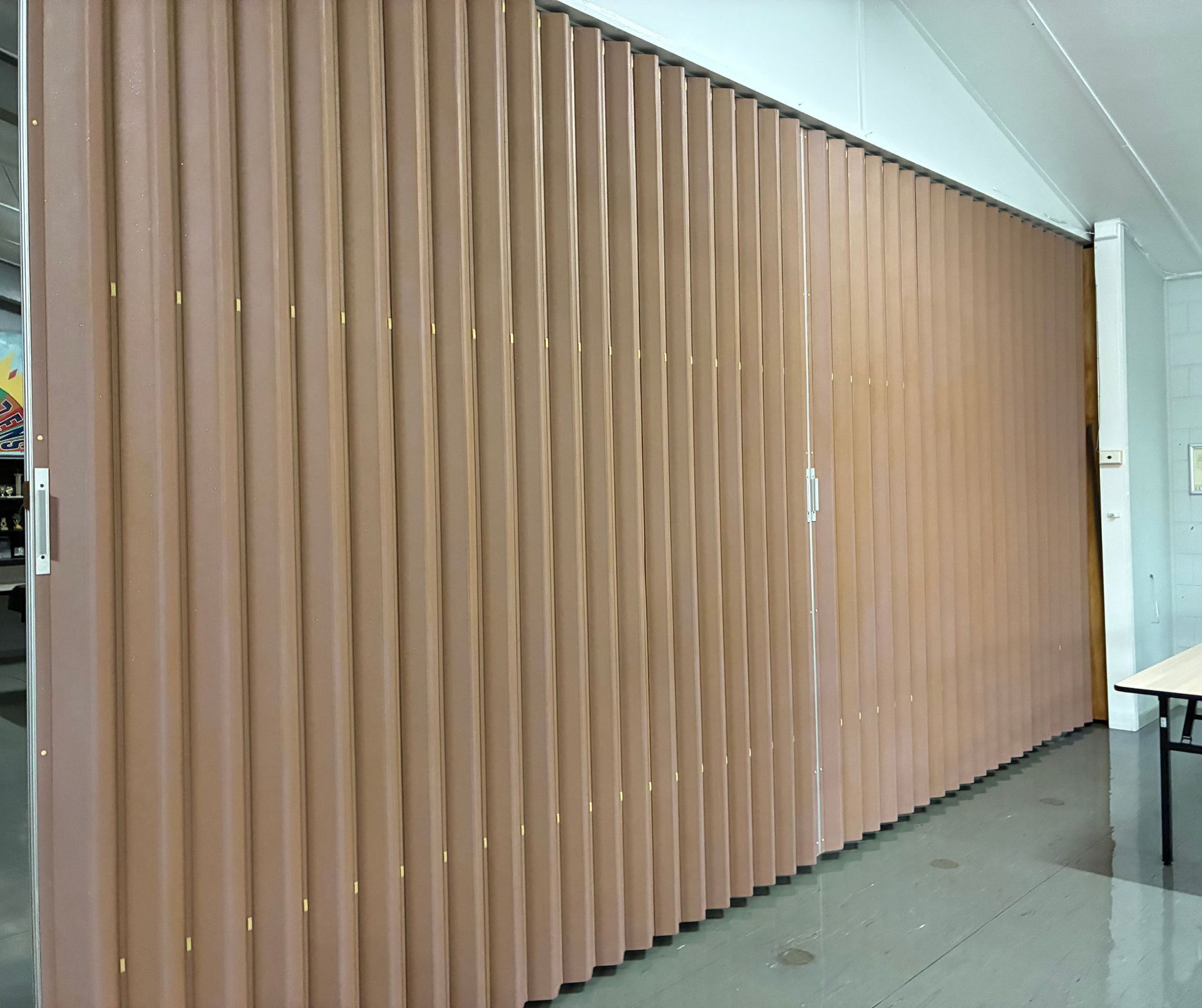 Brown Accordion-style Room Divider in a White-walled Room, Partially Open — Schmucker Cleaning in Gulliver, QLD
