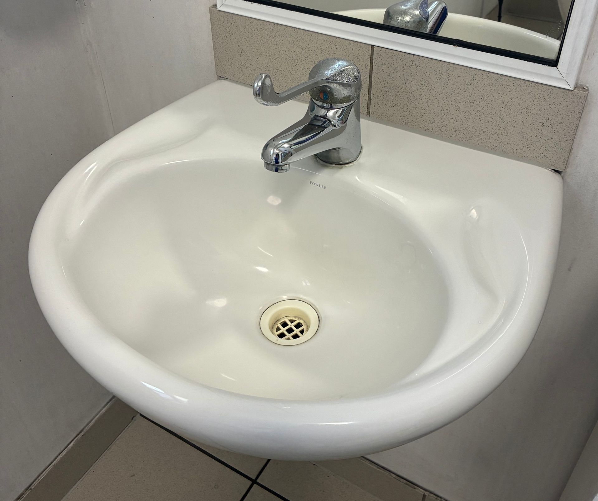 White Ceramic Sink With Chrome Faucet in a Bathroom — Schmucker Cleaning in Gulliver, QLD