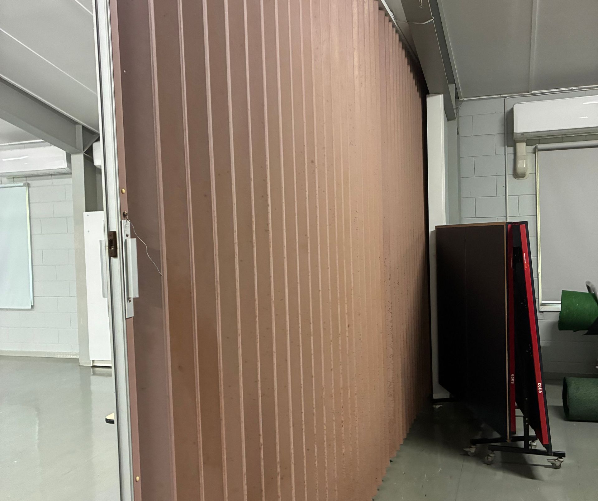 Large, Brown, Accordion-style Folding Wall in a Room — Schmucker Cleaning in Gulliver, QLD