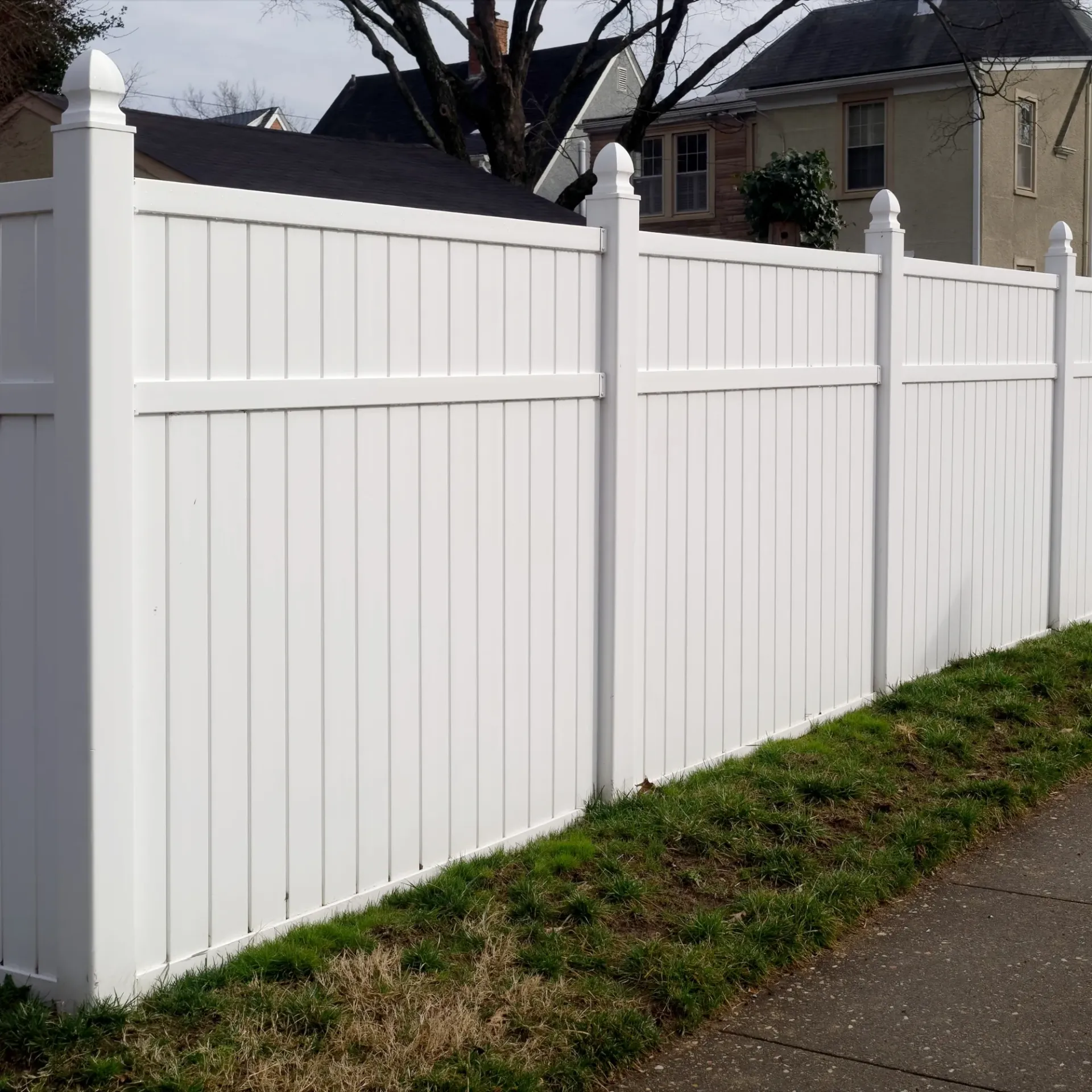 Boots & Boards Fencing - A white fence along a sidewalk in front of a house