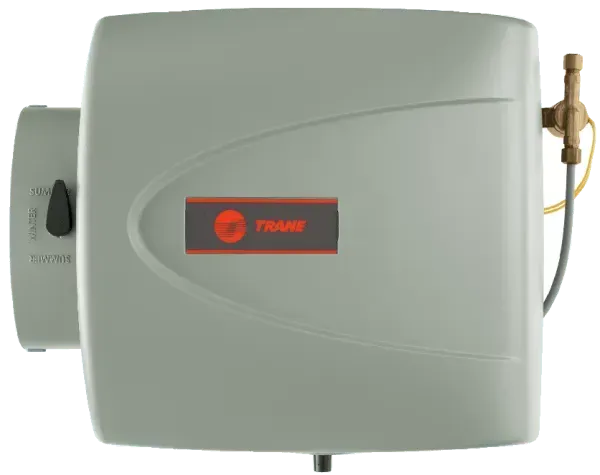 Gray Trane humidifier with a knob, water valve, and logo on a wall.