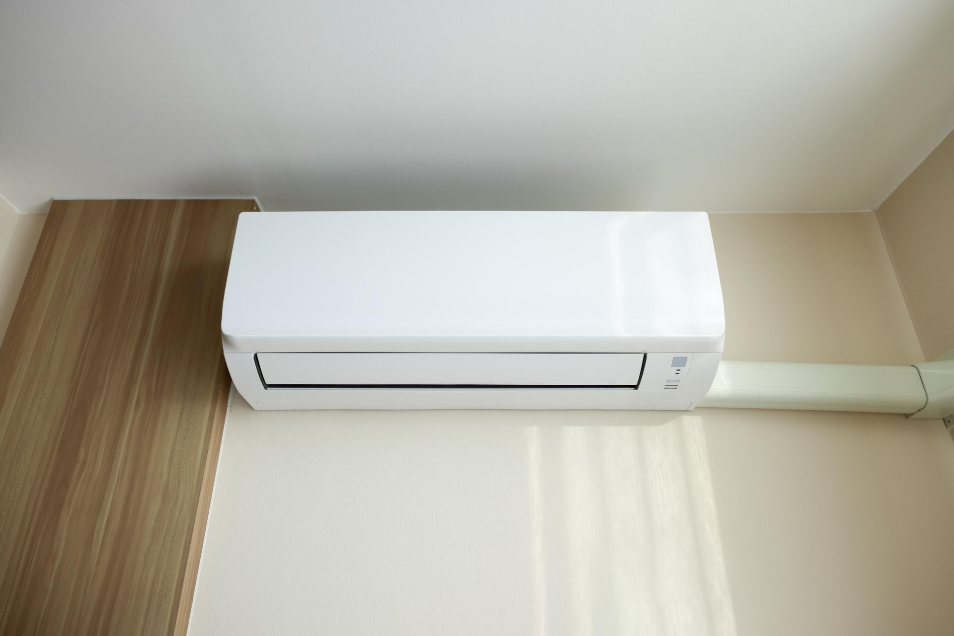 White wall-mounted air conditioner unit. 