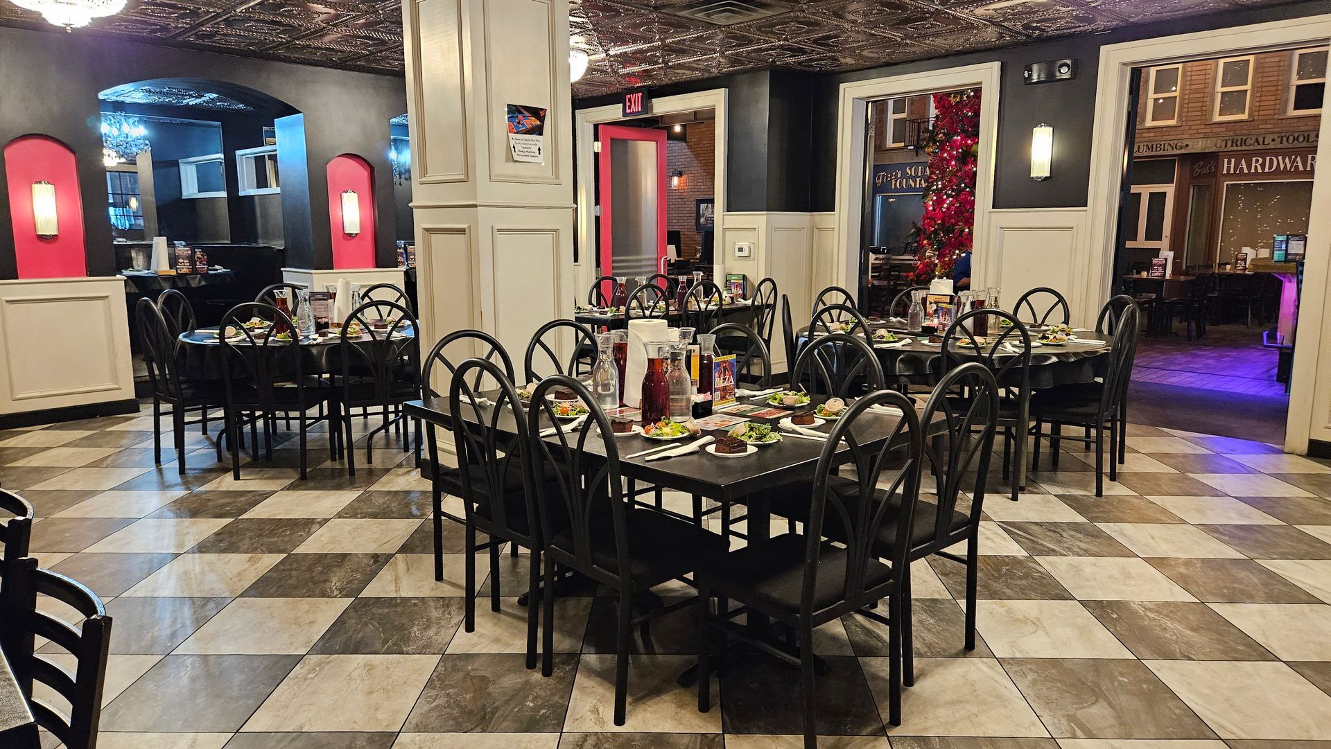 A restaurant with tables and chairs and a checkered floor.