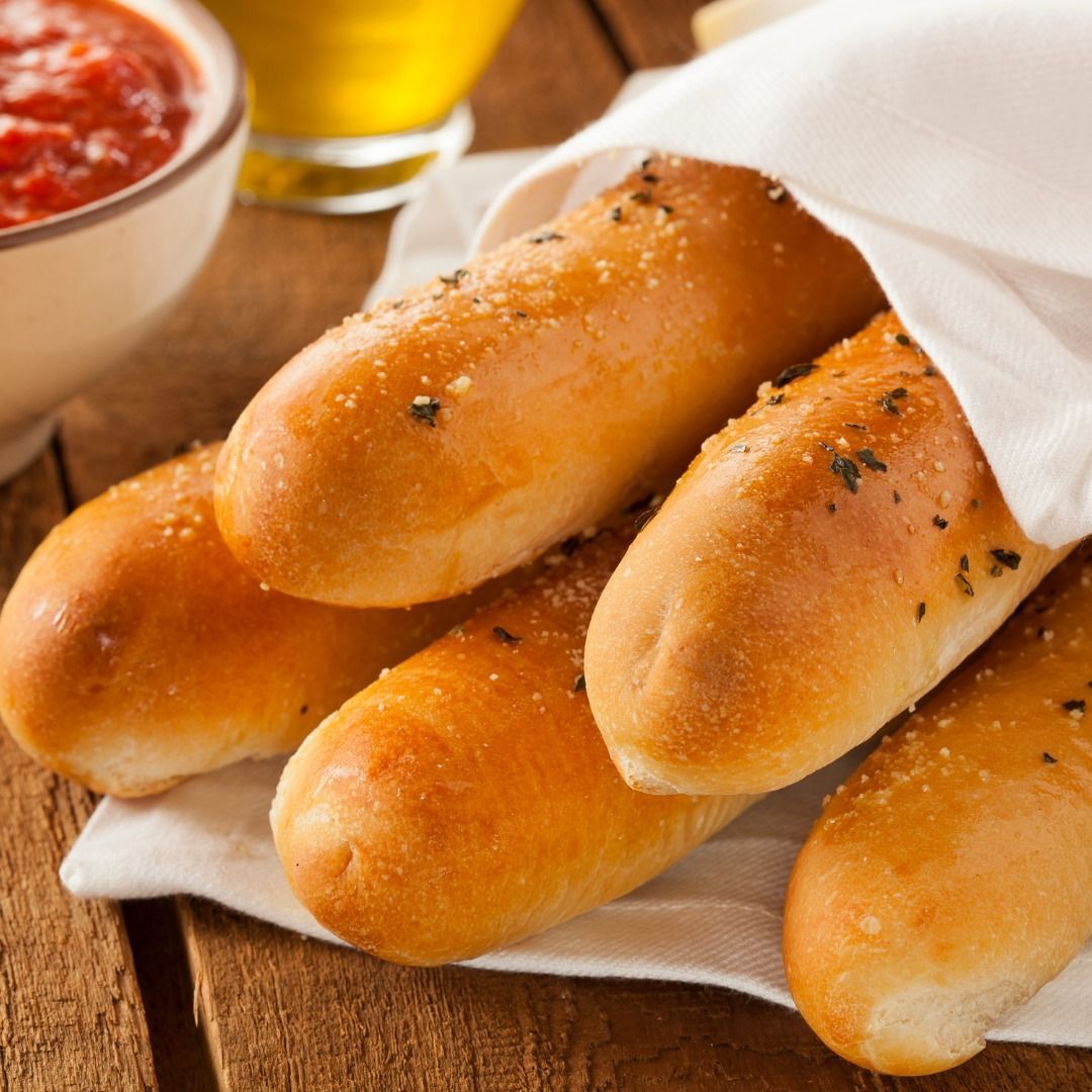 A bunch of hot dogs wrapped in a napkin on a table