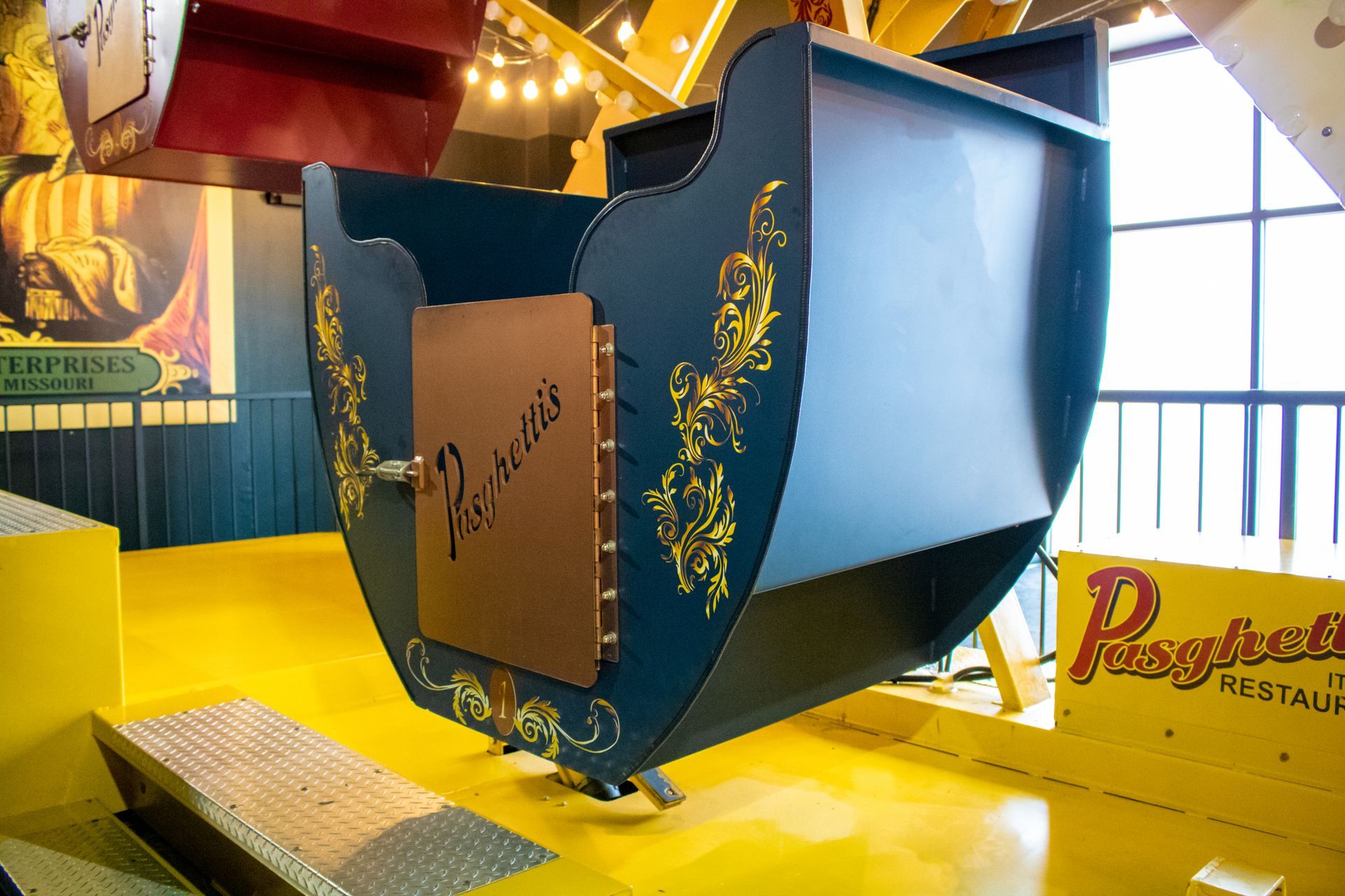 A large sleigh is sitting on a yellow floor in a room.