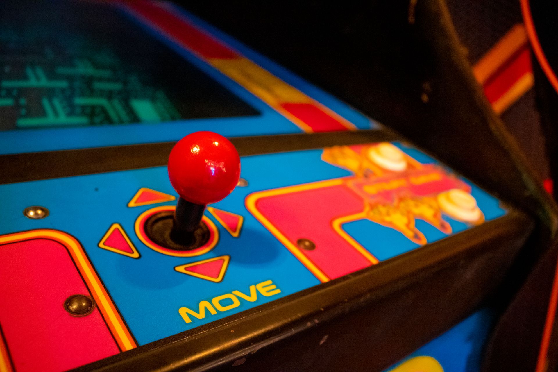 A close up of an arcade game with a red button that says move