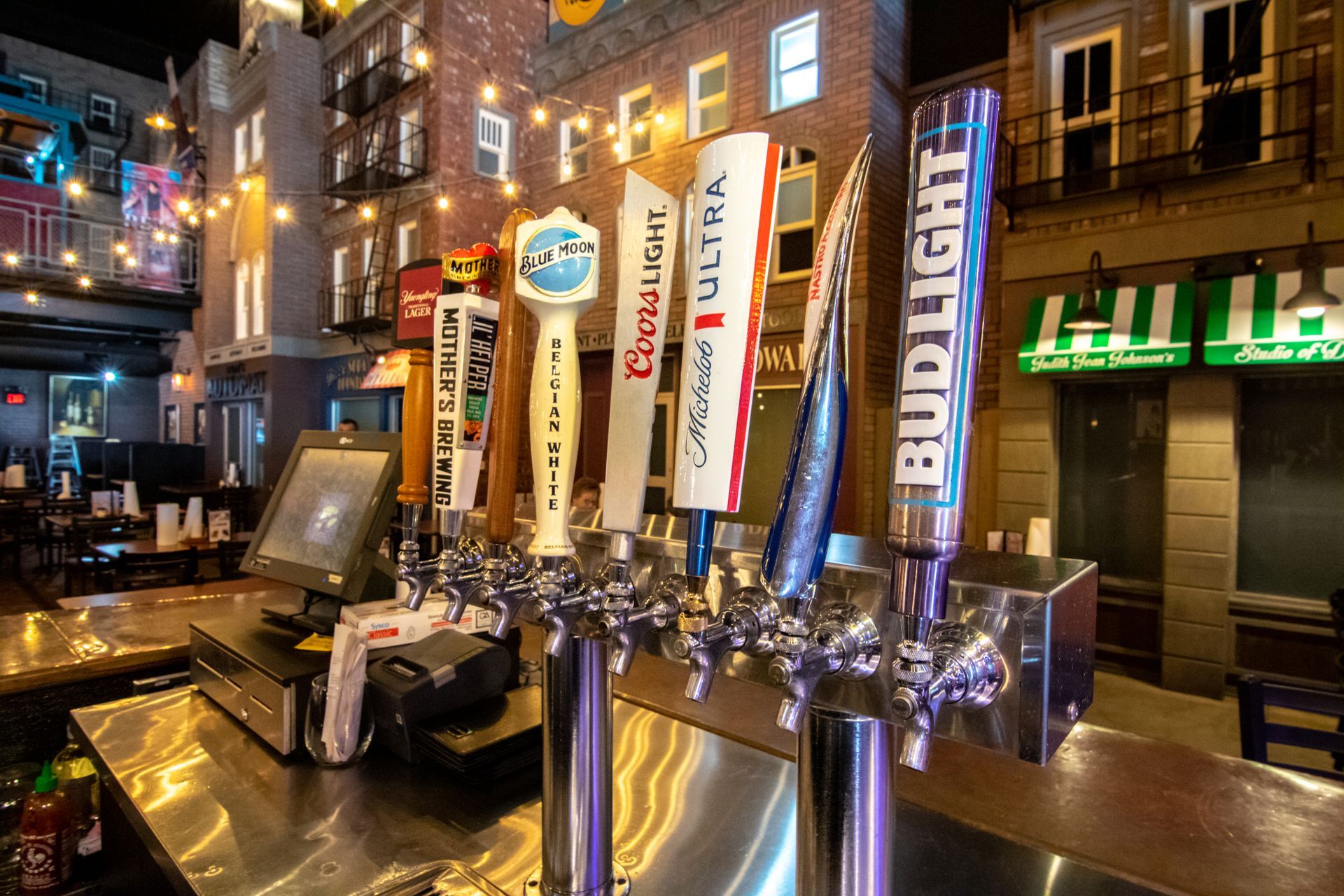 A bar with a bunch of beer taps on it.