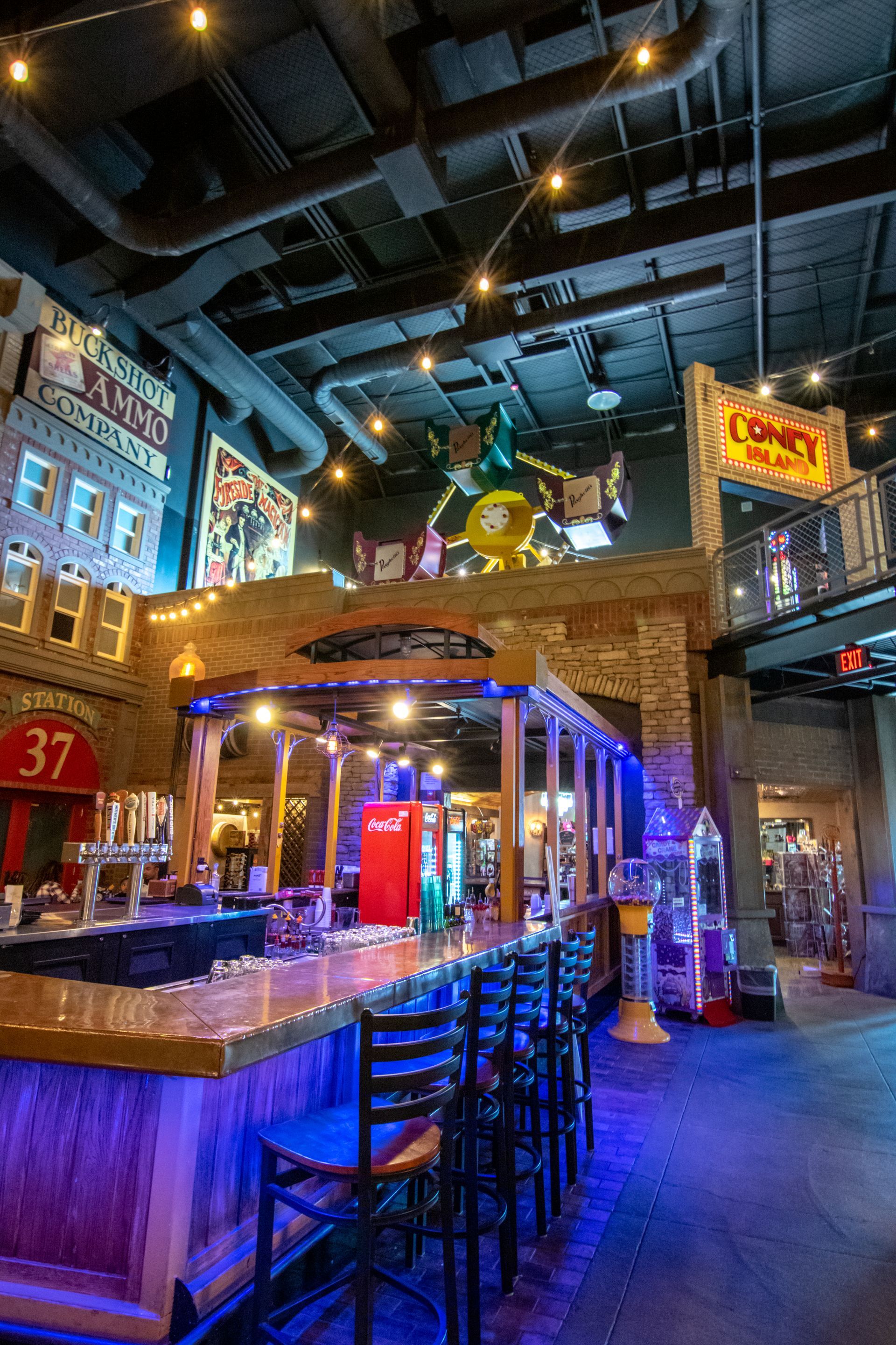 A restaurant with tables and chairs and a bar.