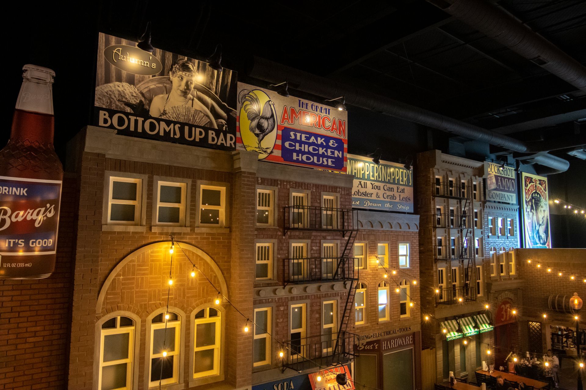 A brick building with a sign that says bottoms up bar
