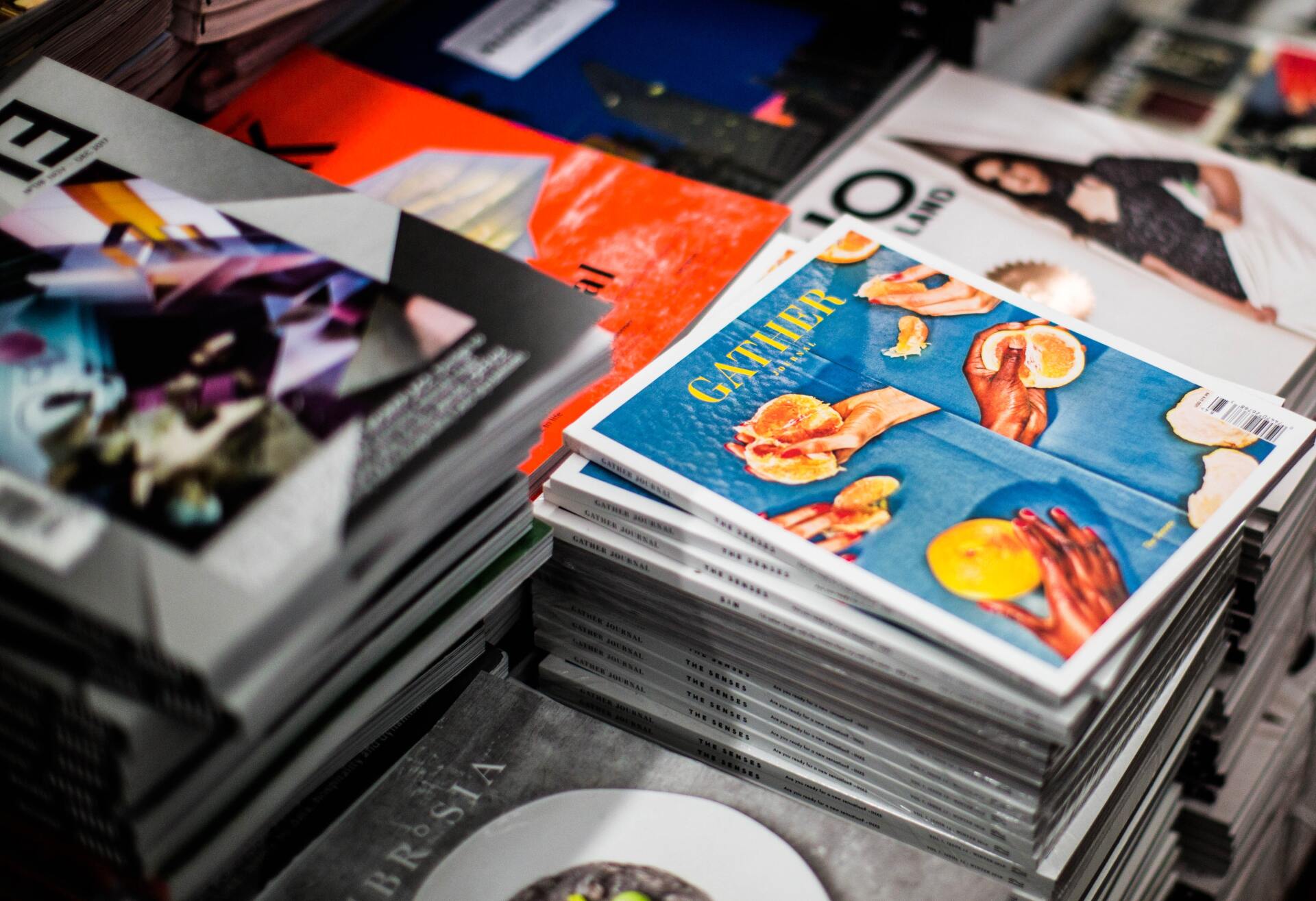A stack of magazines sitting on top of each other on a table.