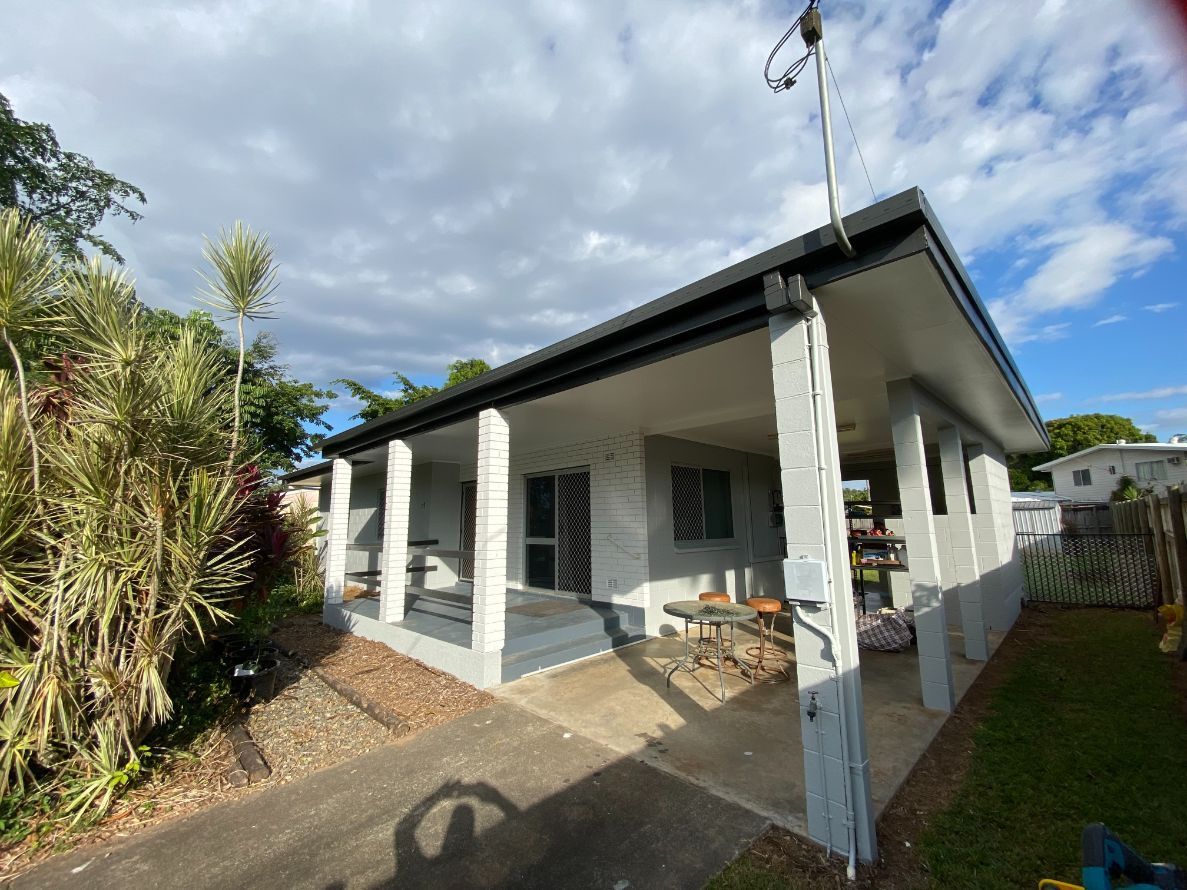 A Freshly Painted White House with A Green Gutter— Painting & Maintenance FNQ Handyman Service in Clifton Beach, QLD