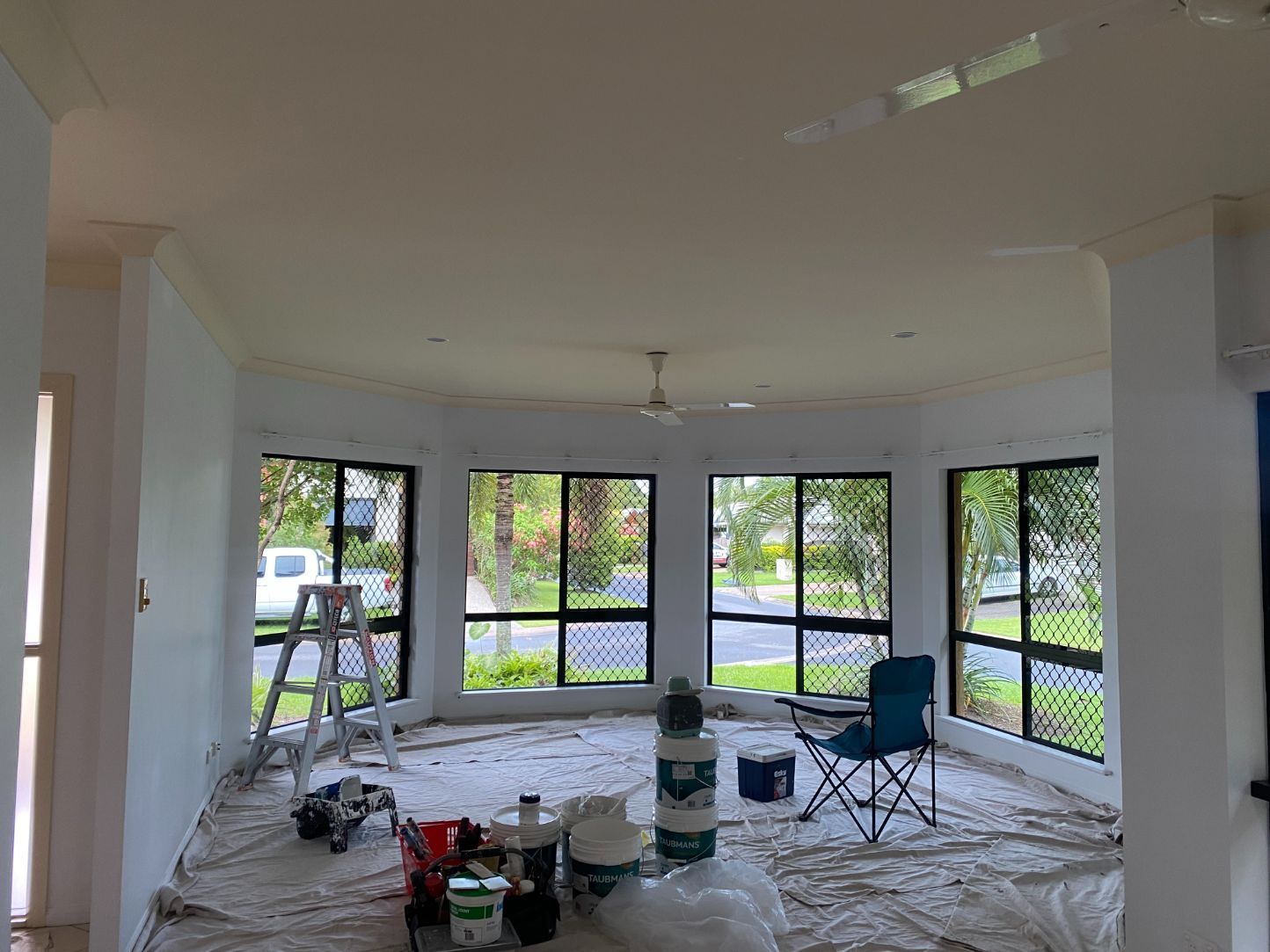 A White Living Room with Painting Tools — Painting & Maintenance FNQ Handyman Service in Clifton Beach, QLD
