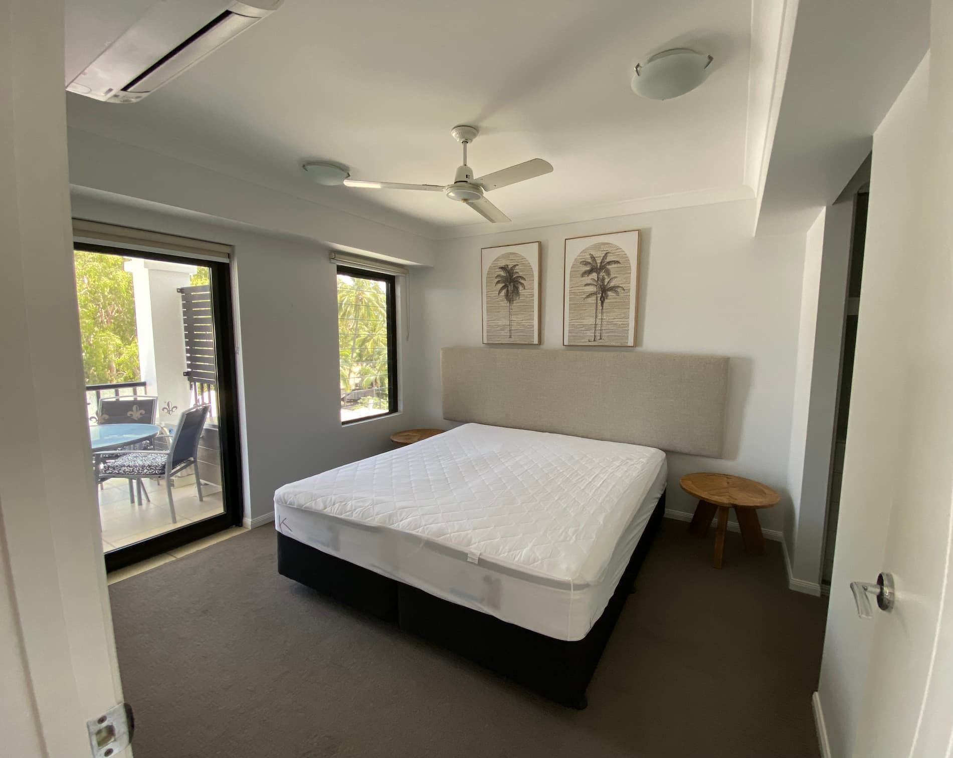 A Bedroom with A Large Bed and A Ceiling Fan — Painting & Maintenance FNQ Handyman Service in Clifton Beach, QLD