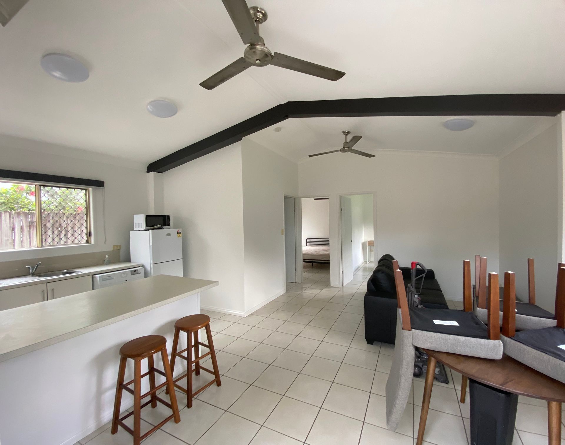 A Kitchen With a Ceiling Fan and a Table and Chairs — Painting & Maintenance FNQ Handyman Service in Clifton Beach, QLD
