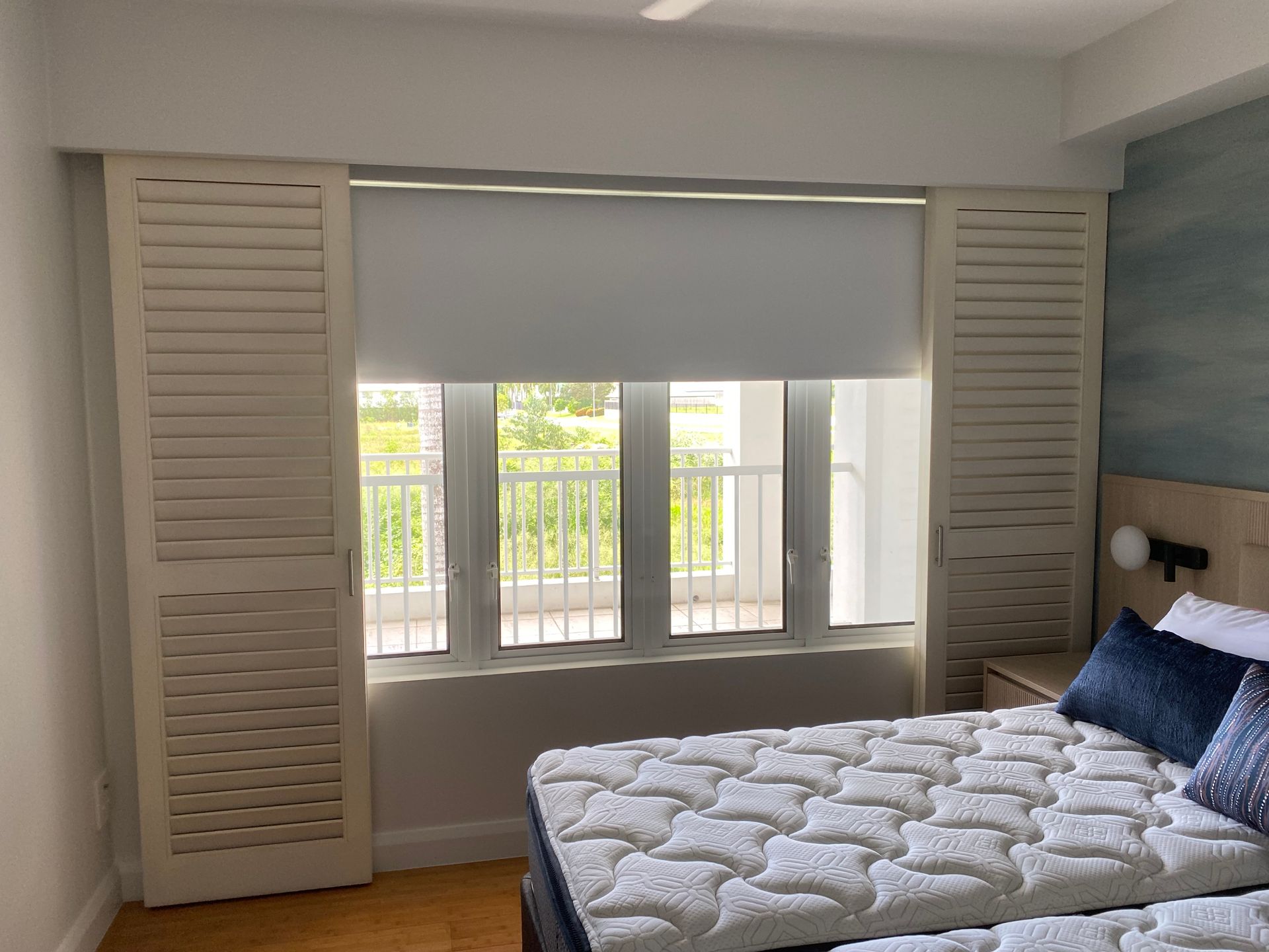 A Bedroom With Two Beds and a Window With Blinds — Painting & Maintenance FNQ Handyman Service in Clifton Beach, QLD