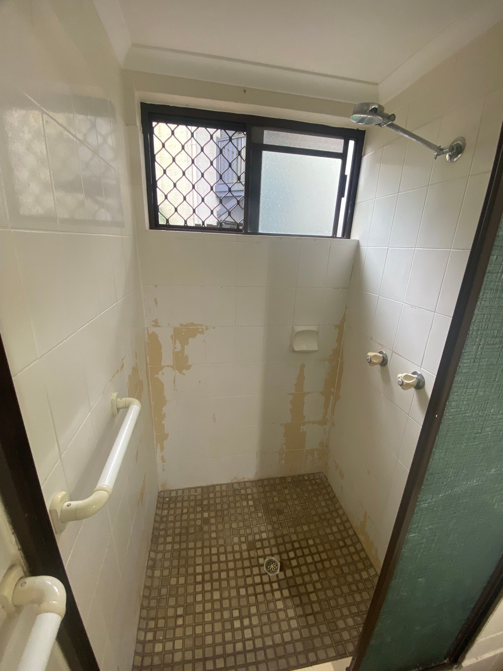 A bathroom with a shower and a window — Painting & Maintenance FNQ Handyman Service in Clifton Beach, QLD
