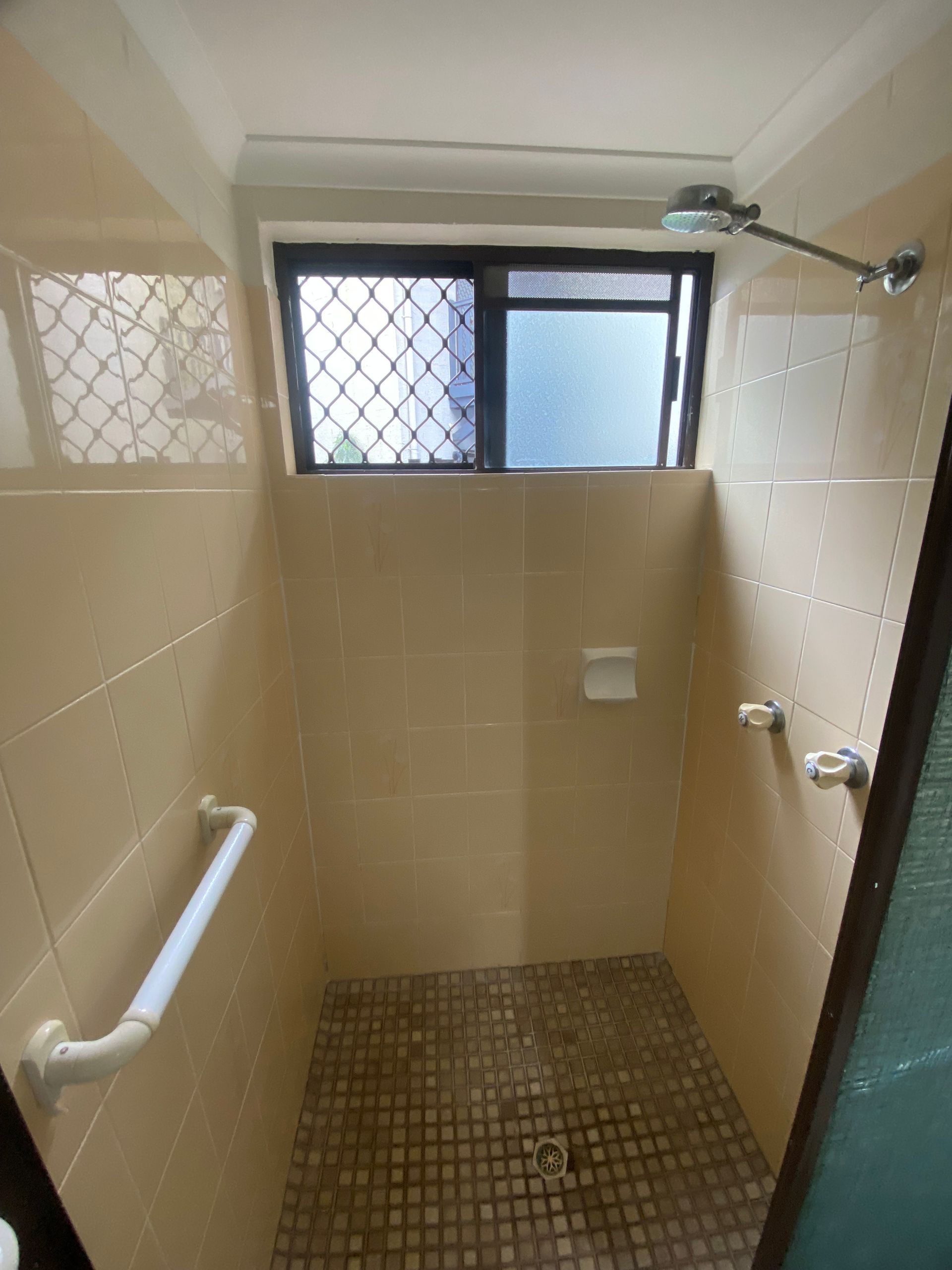 A bathroom with a shower and a window — Painting & Maintenance FNQ Handyman Service in Clifton Beach, QLD