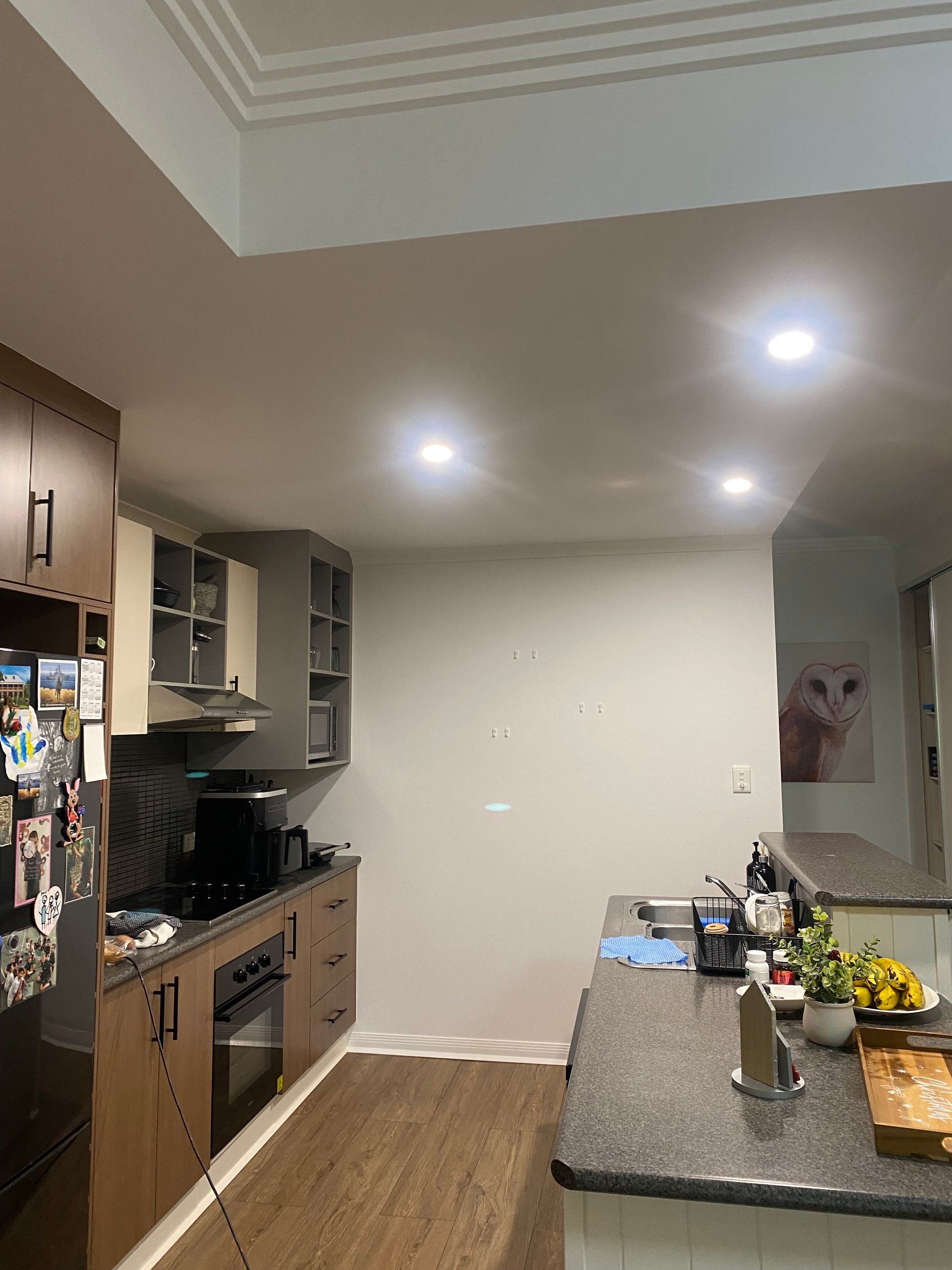 A kitchen with a refrigerator, stove, sink, and cabinets — Painting & Maintenance FNQ Handyman Service in Clifton Beach, QLD