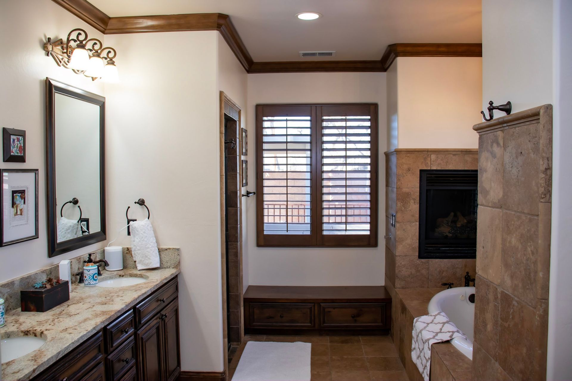 a bathroom with two sinks and a fireplace