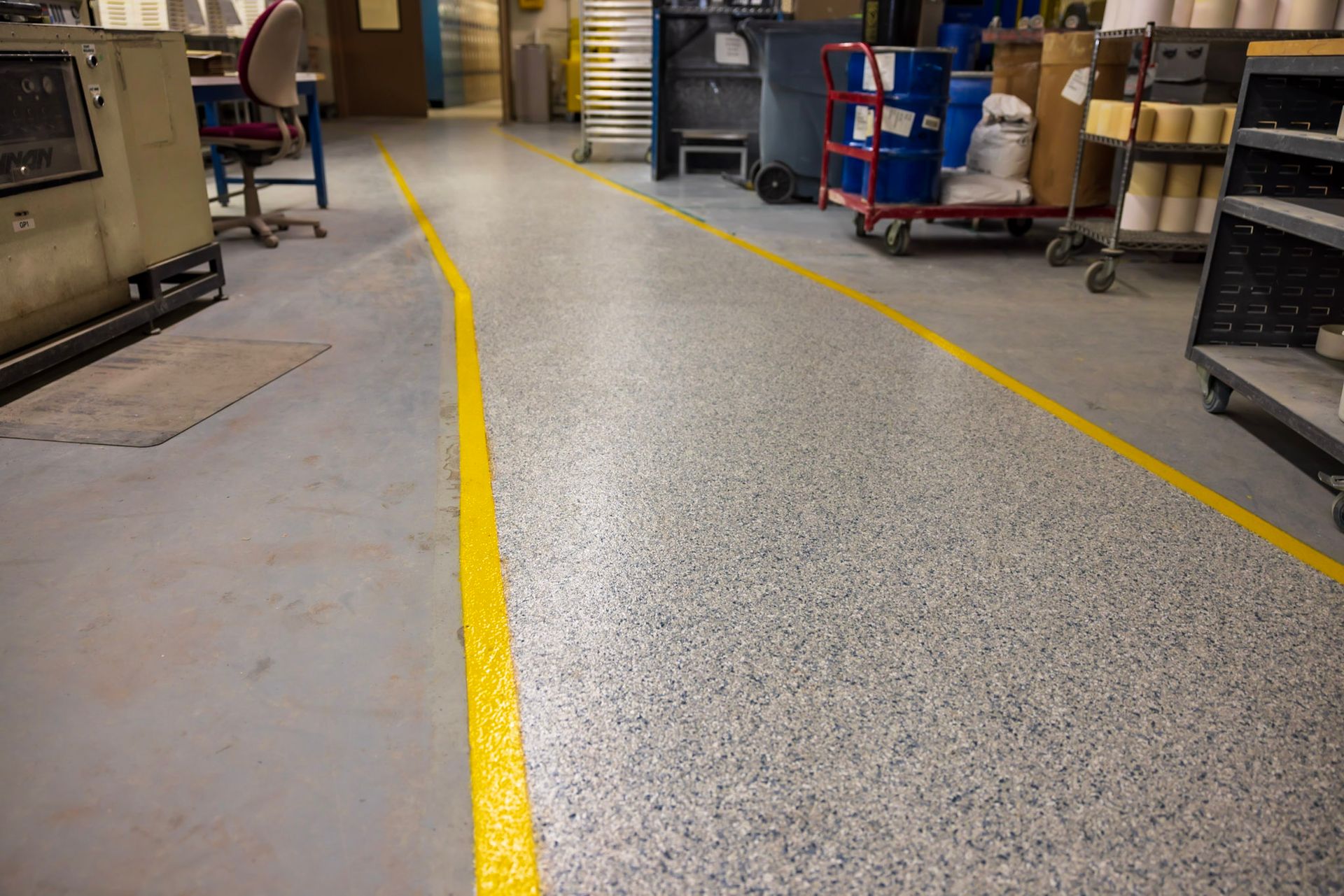 a warehouse with a yellow line on the floor .