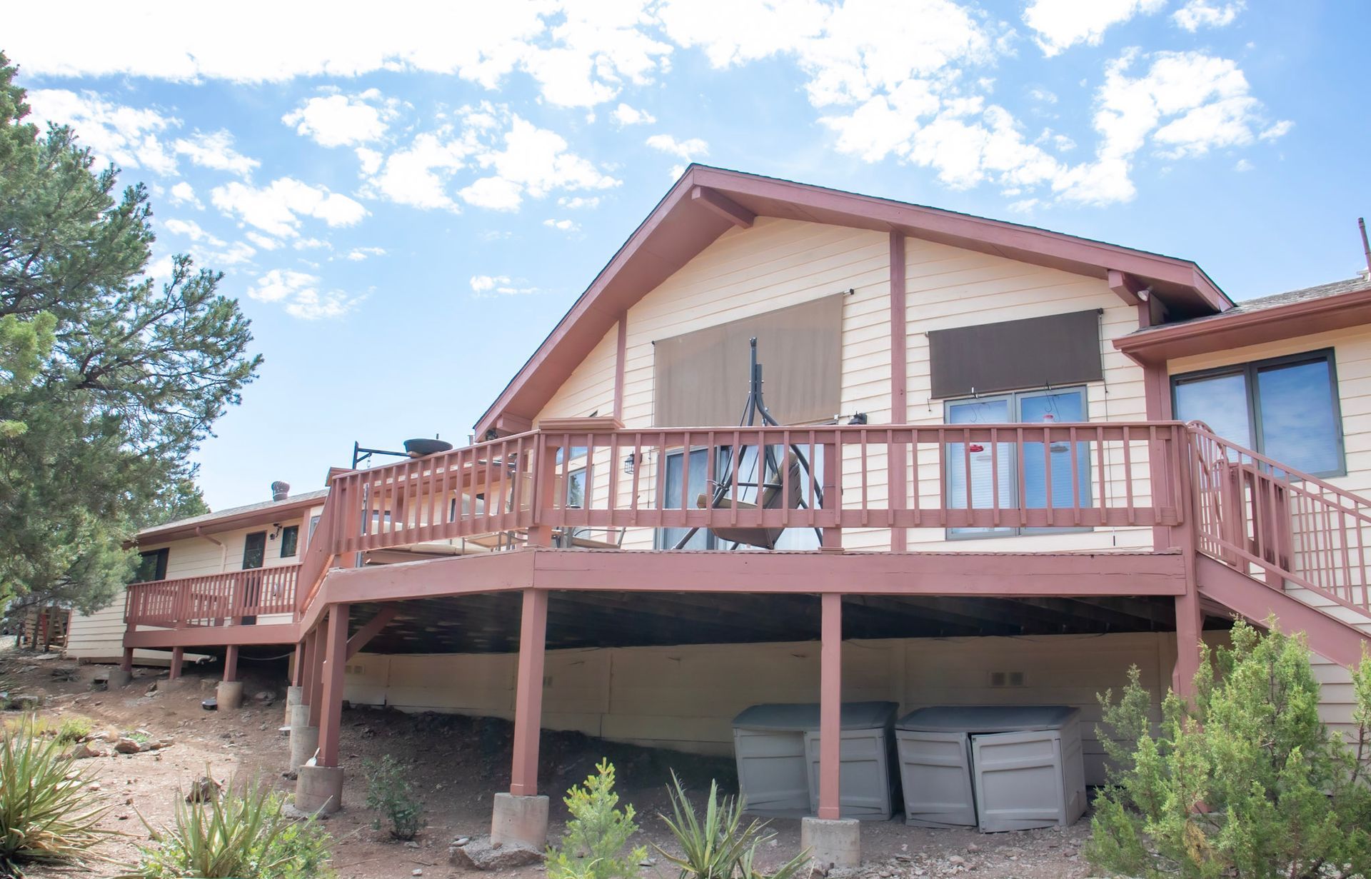 a large house with a large deck and stairs