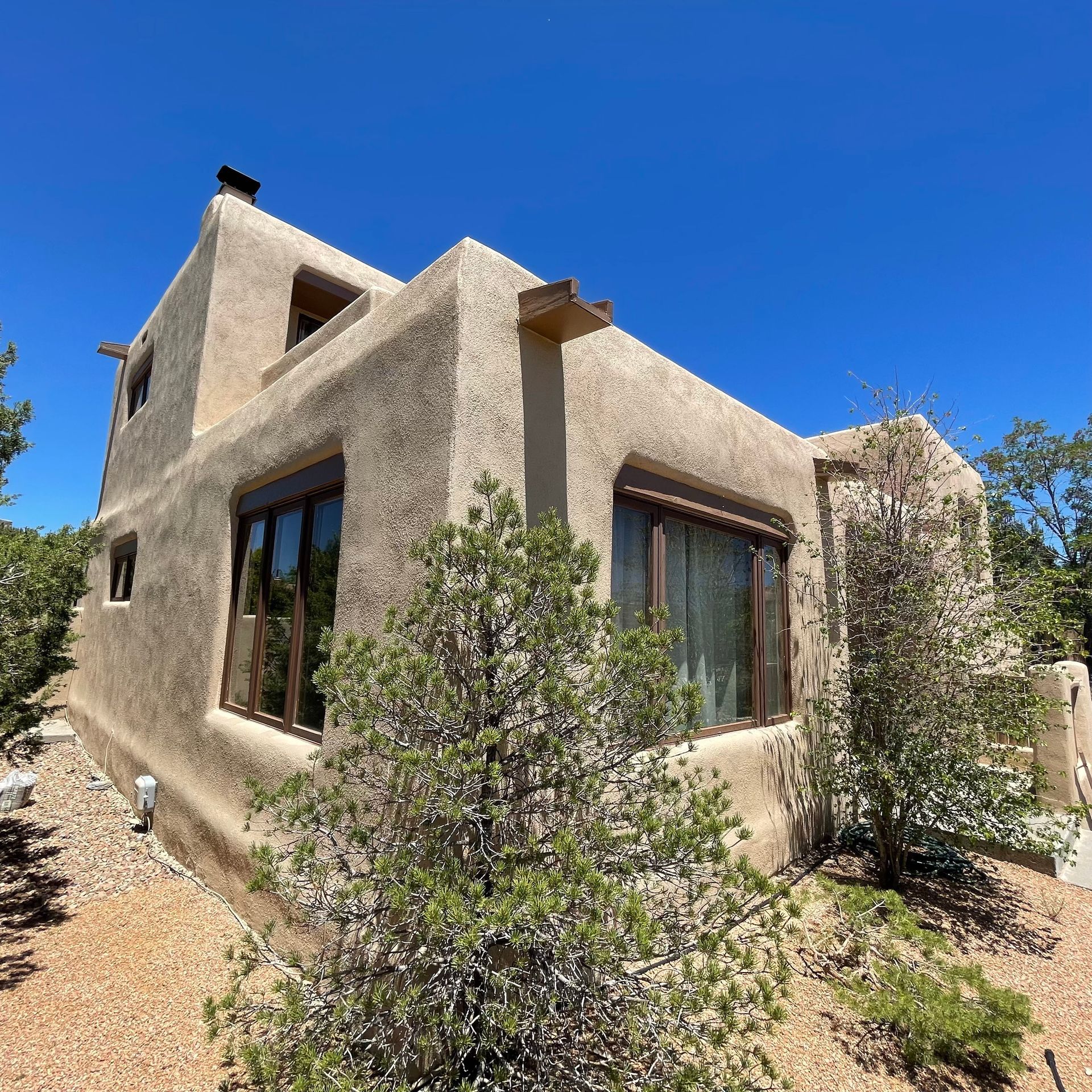 a house with a lot of windows and a blue sky in the background