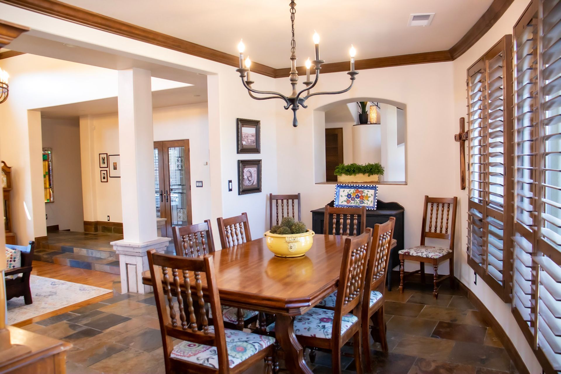a dining room with a table and chairs and a chandelier