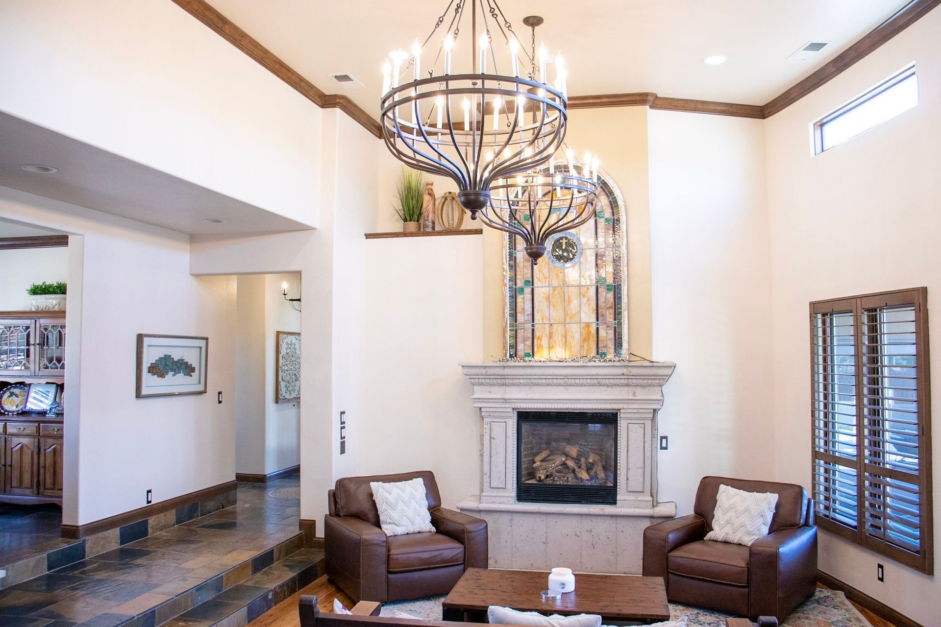 a living room with a fireplace and a chandelier