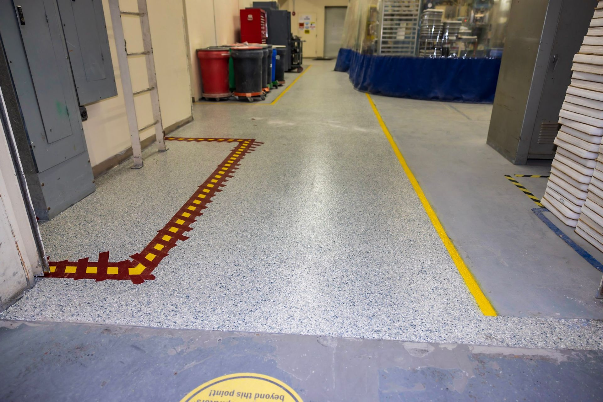 a warehouse with a yellow line on the floor