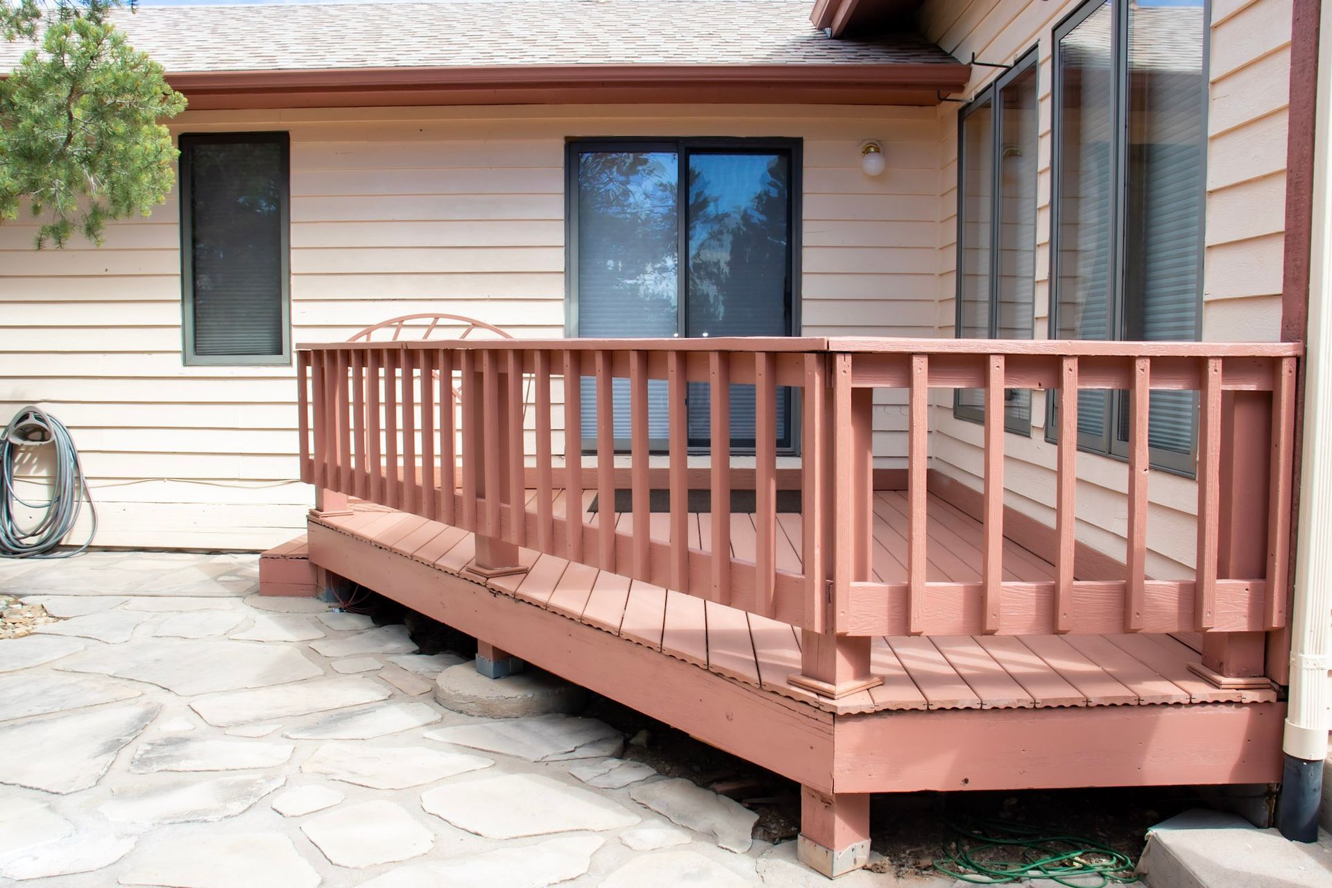 a house with a sliding glass door and a wooden deck
