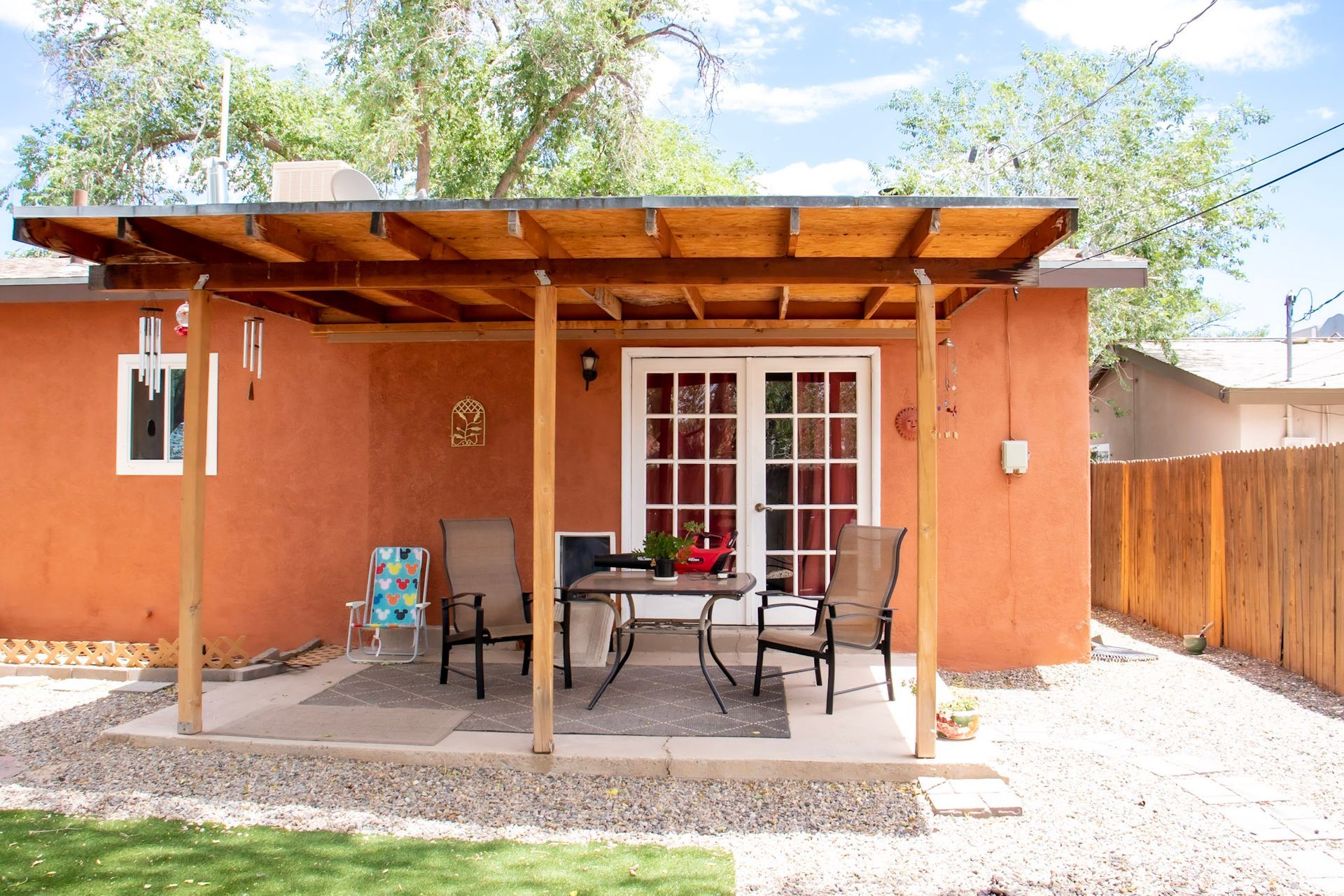 a house with a covered patio with a table and chairs
