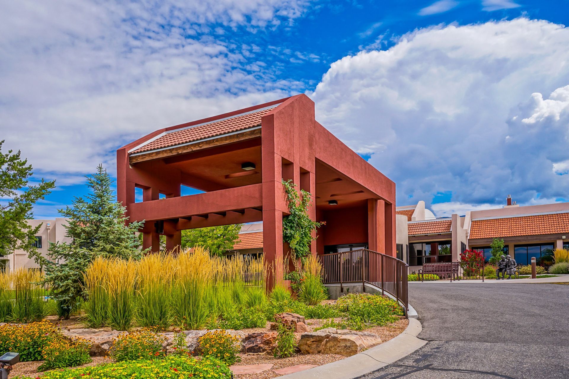 a large red building with a blue sky and clouds in the background .