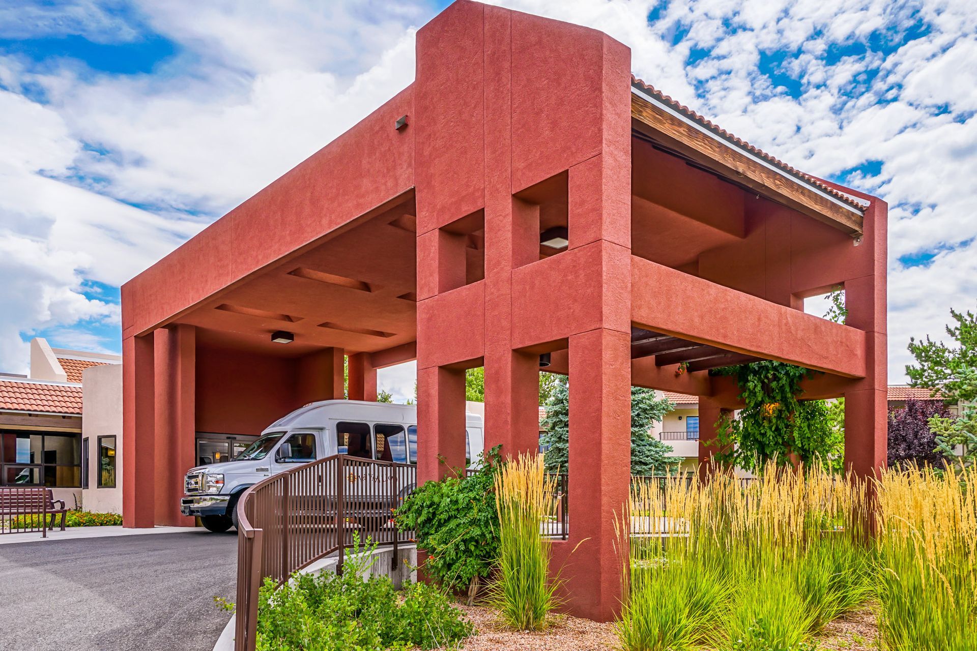 a red building with a white van parked underneath it .