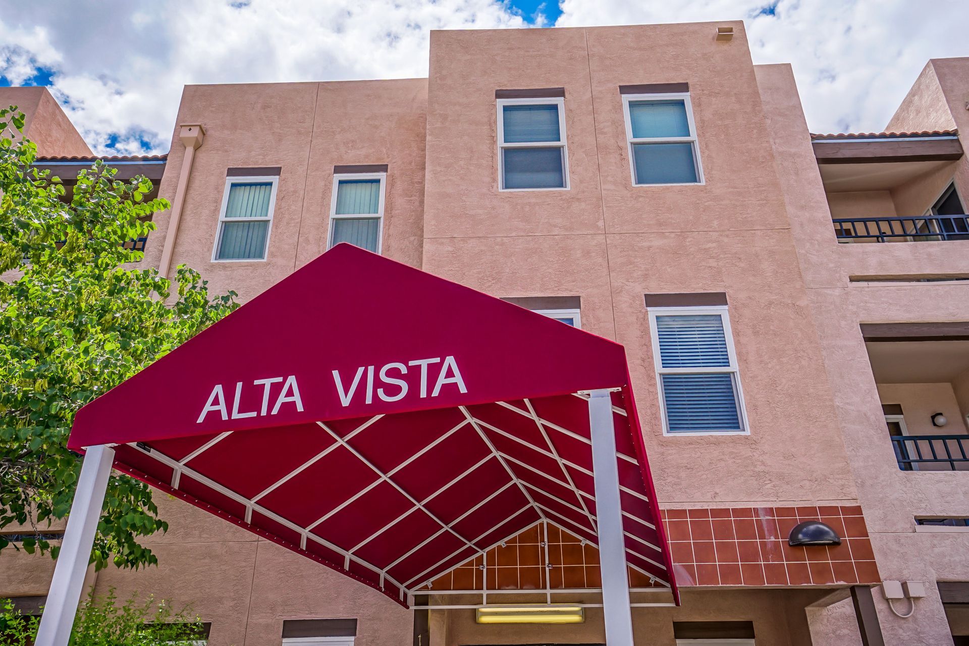 a building with a red awning that says alta vista