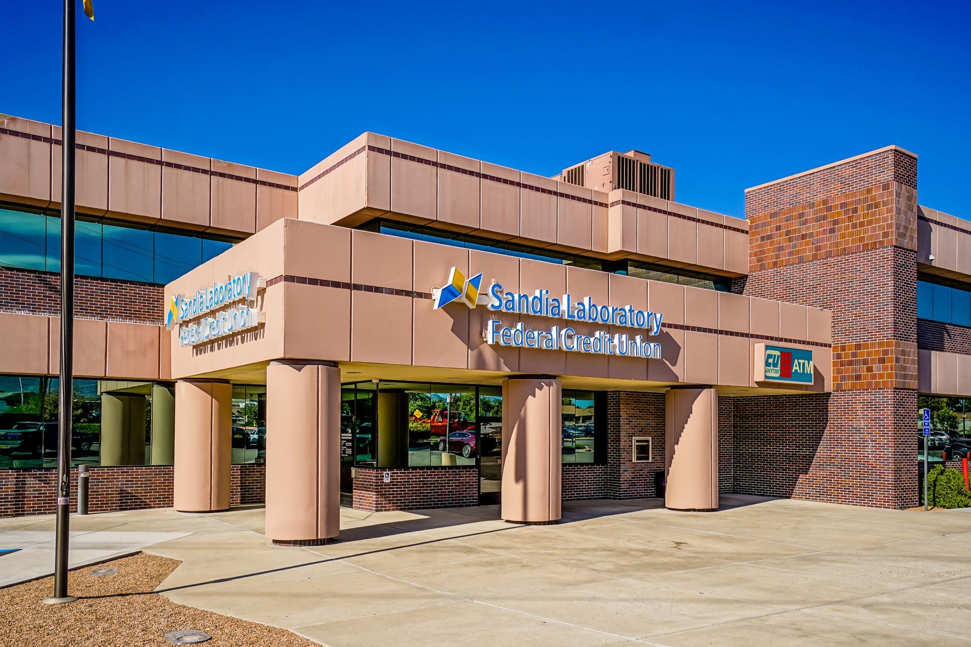 the front of a large building with a flag in front of it .