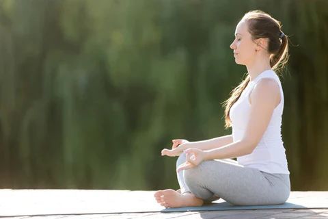 girl sitting cross legged on floor meditating - Relaxation techniques at Casa de Olivos - near Vinaros