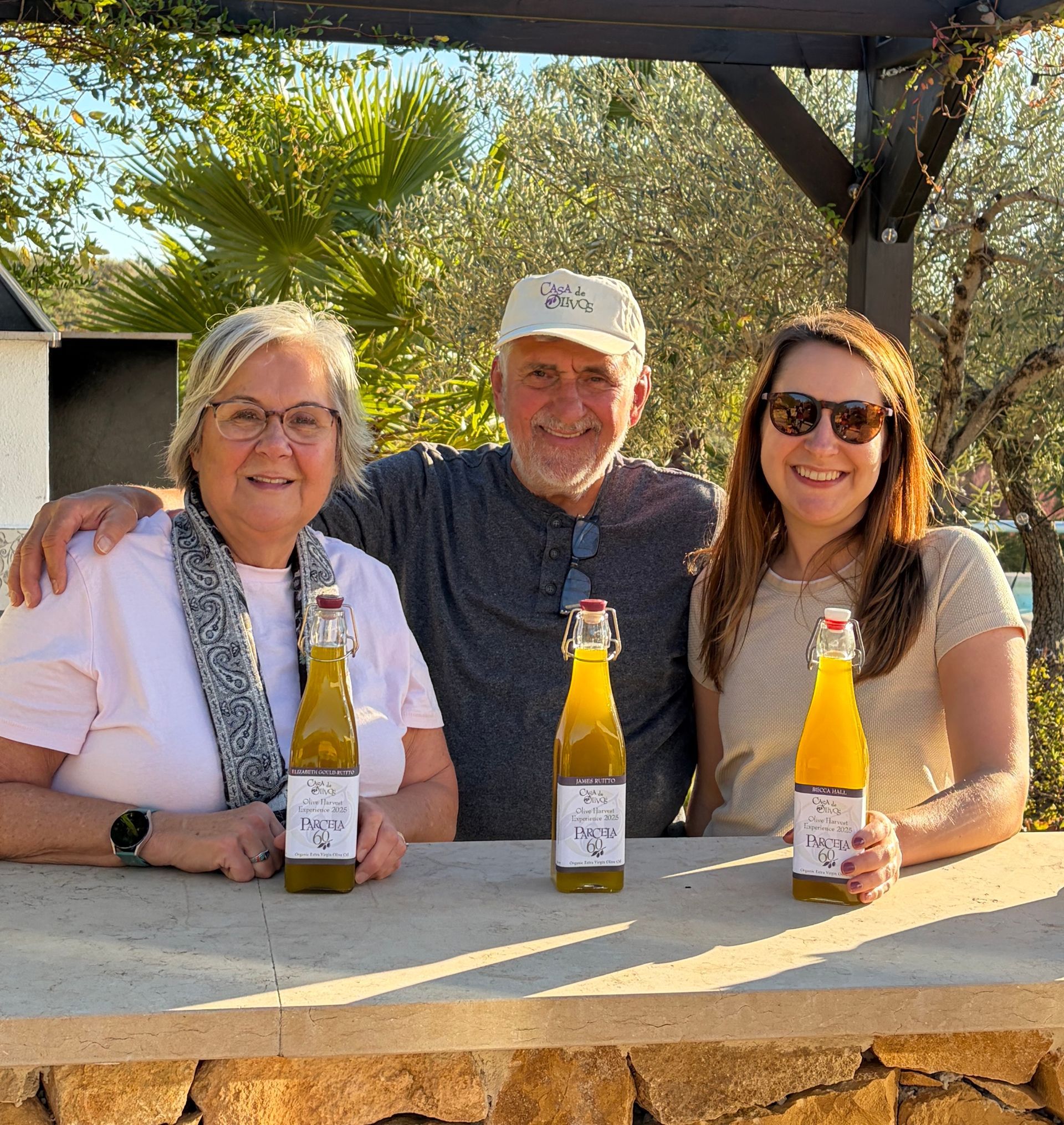 Group of guests showing off their bottles of oil from the Casa de Olivos olive harvest experience in Traiguera