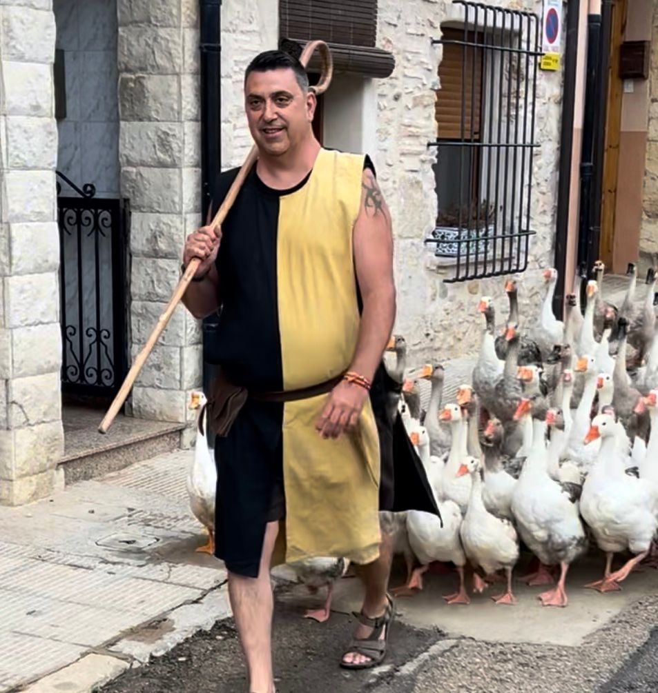 man with ducks in Sant Mateu fiesta near Casa de Olivos